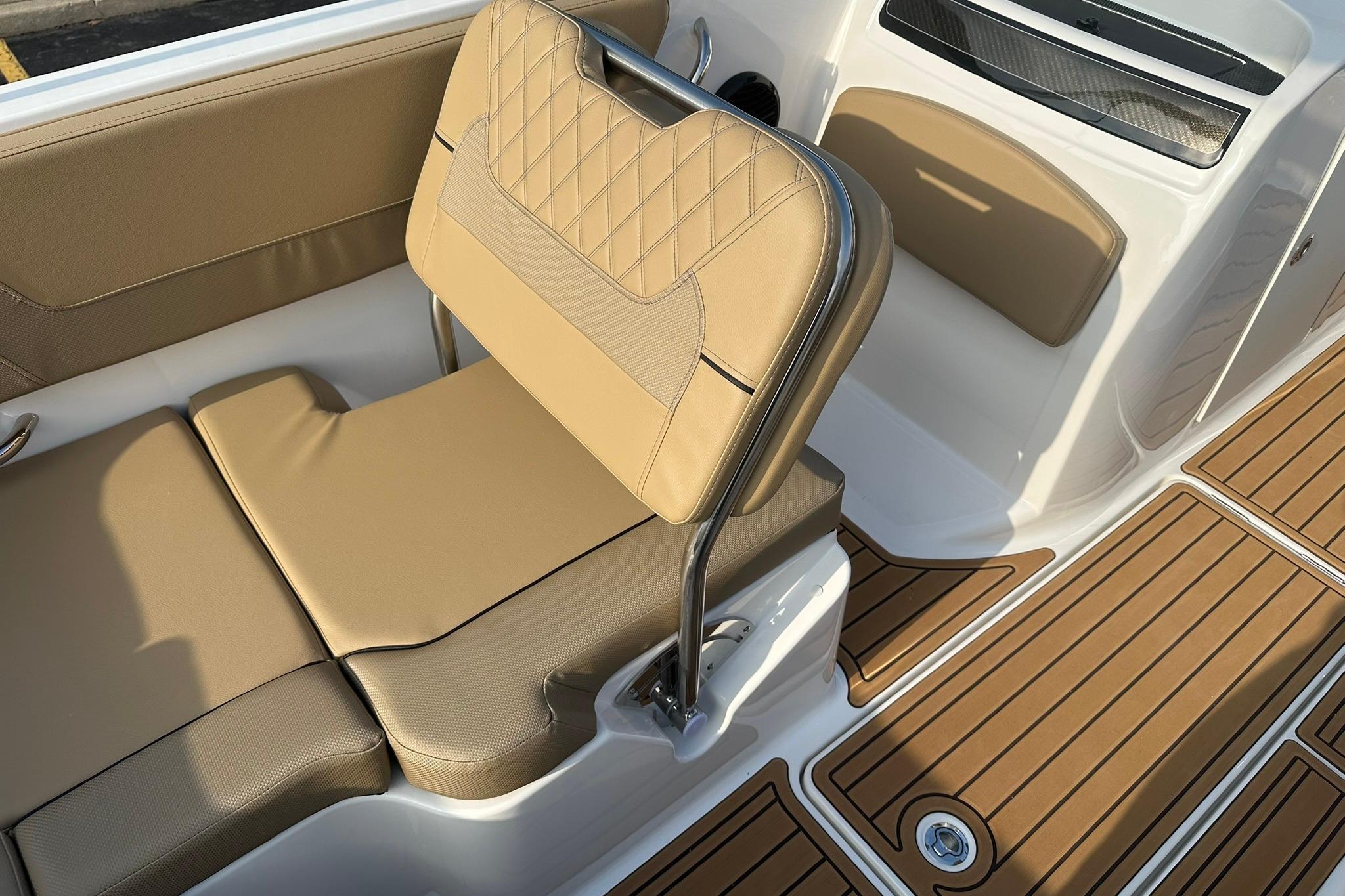 2026 Bayliner VR6 Bowrider OB interior with tan seating and wood-patterned flooring.