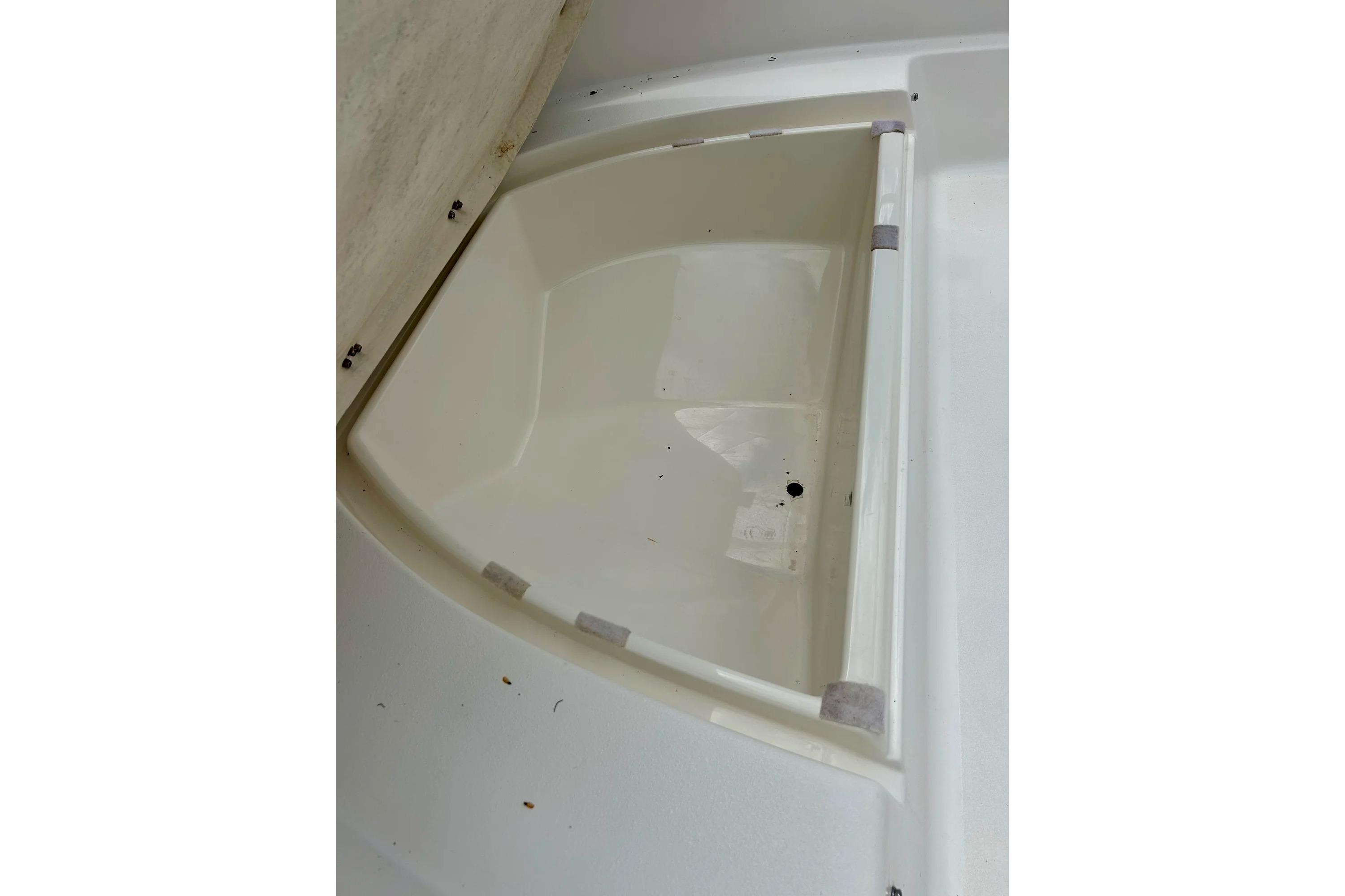 1997 Wellcraft 160 Fisherman boat storage compartment, open and empty.