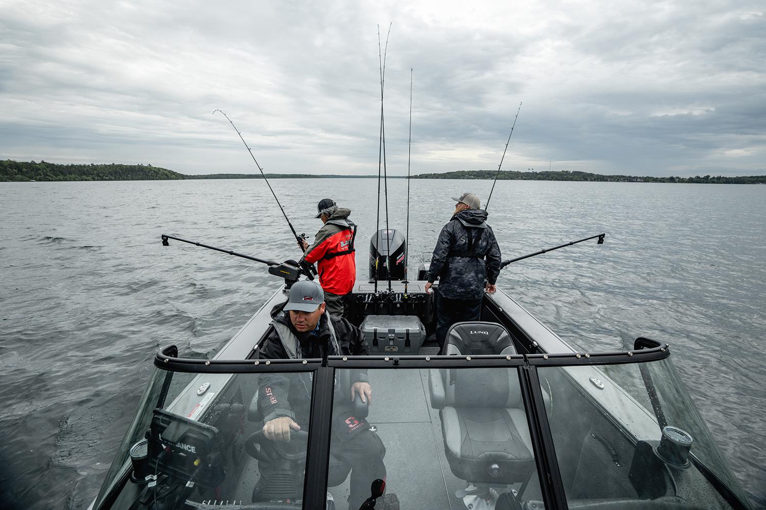 Manufacturer Provided Image: Three people fishing on a 2025 Lund 2075 Fisherman boat in a lake.