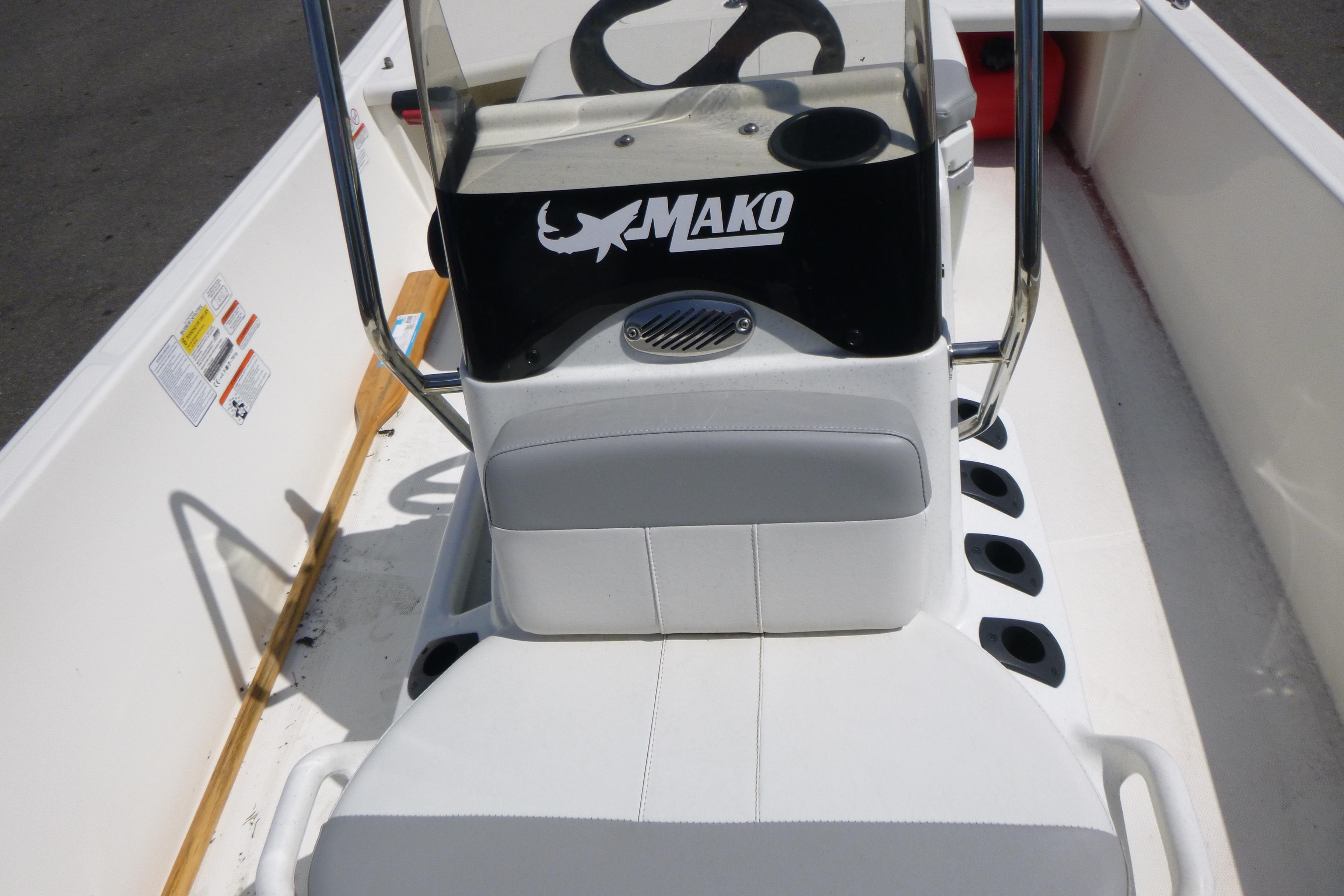 2024 Mako Pro Skiff 17 CC boat interior with steering console and seating.