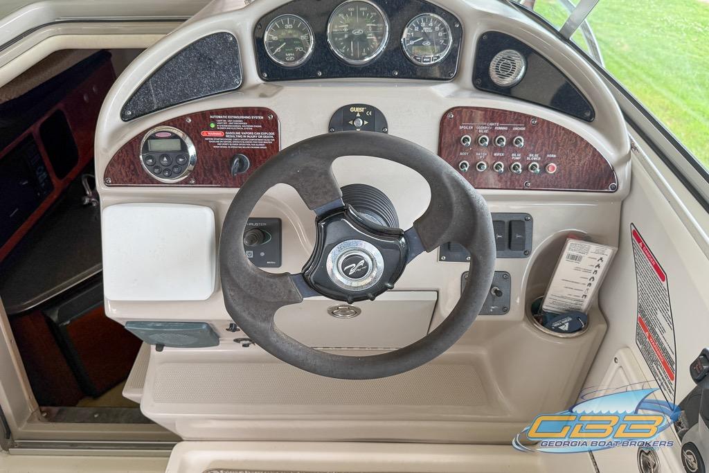 2006 Sea Ray Sundancer 260 helm with steering wheel and control panel.