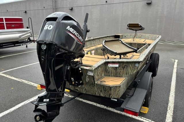 2026 Tracker Grizzly 1756 T Marsh boat with Mercury 50 engine in parking lot.