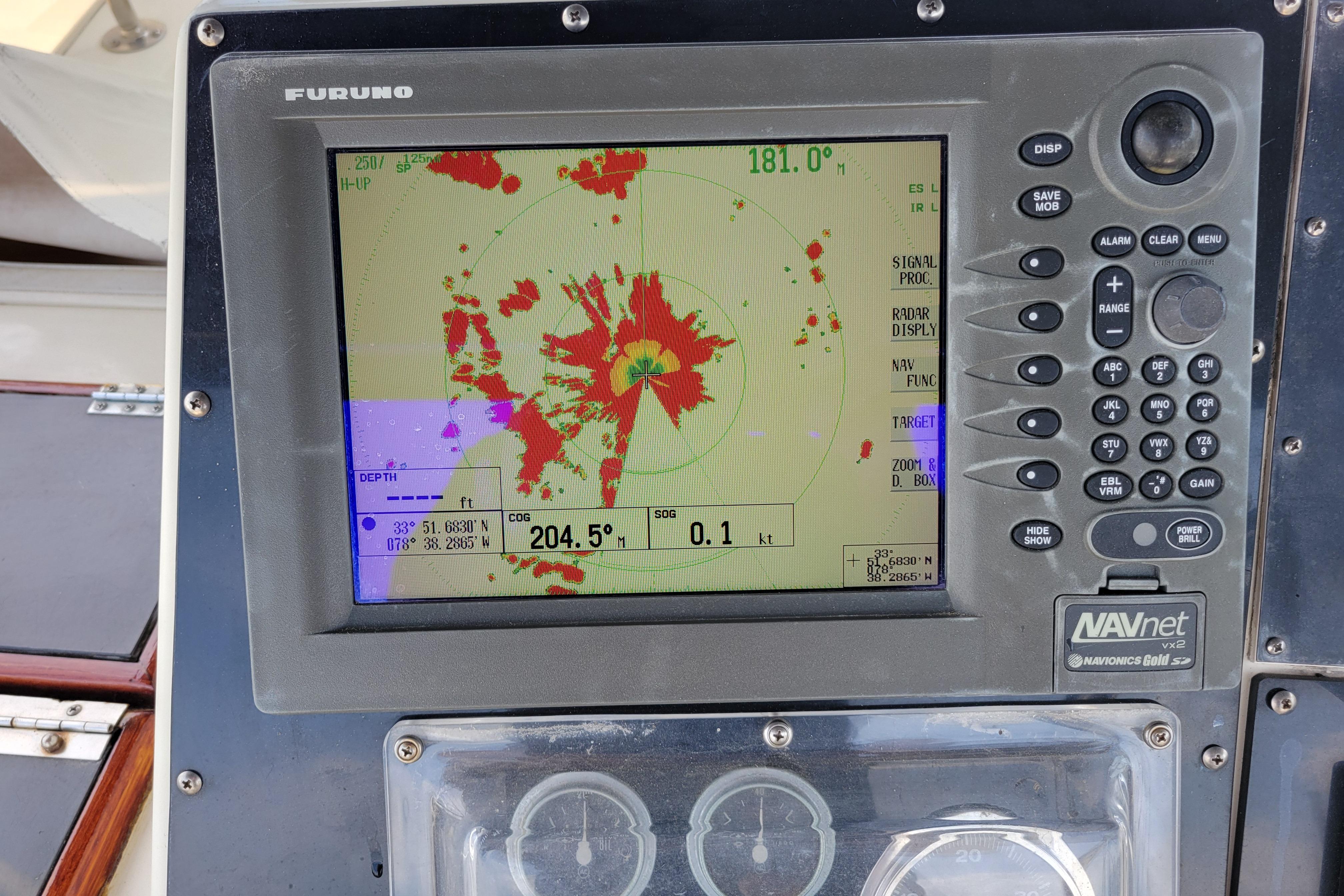 Radar display on 1980 Hatteras 53 Yacht Fisherman showing navigation data and coordinates.