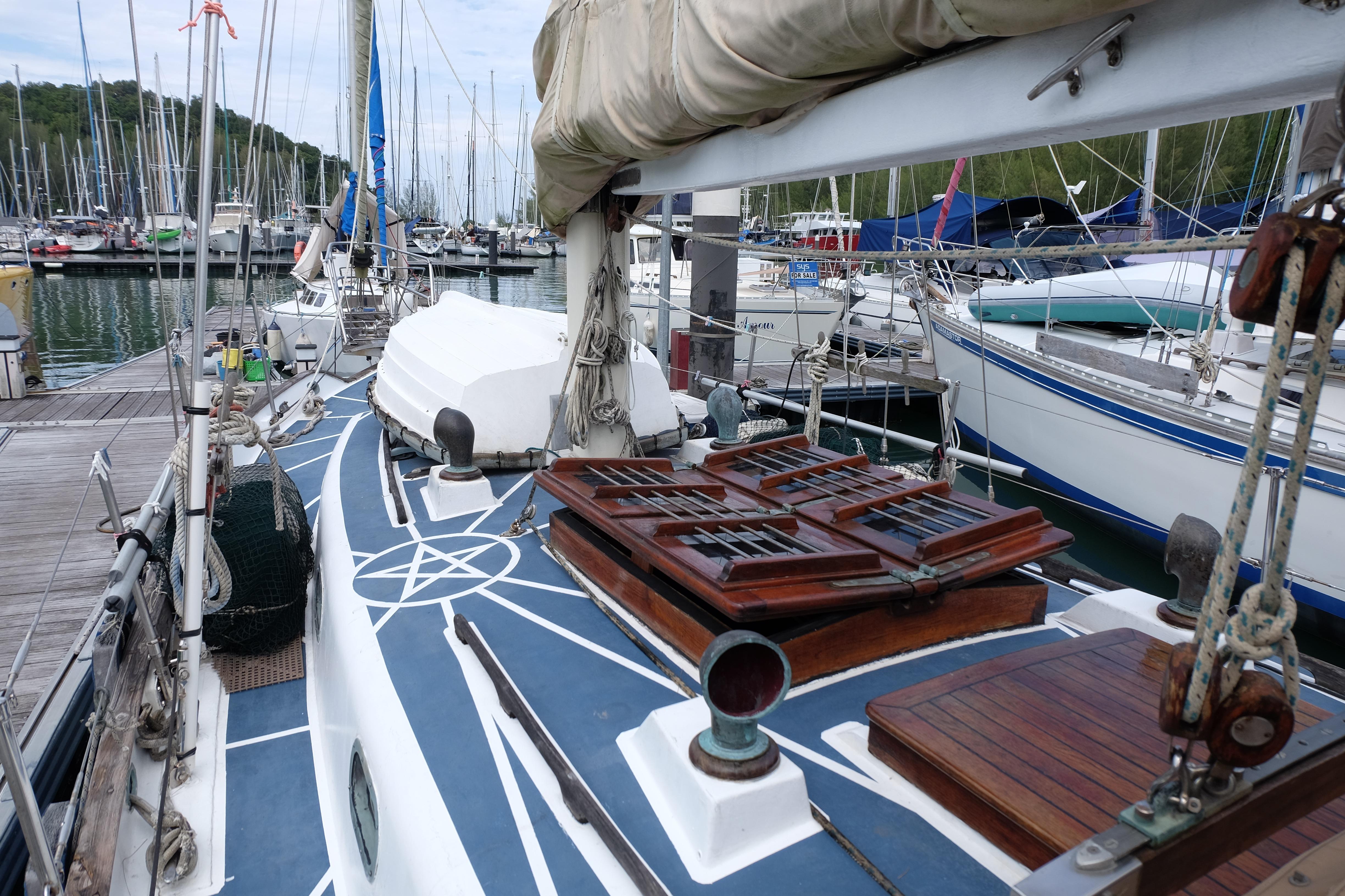 Sailboat docked at marina, Westwind 35 model, 1979, with wooden deck details.