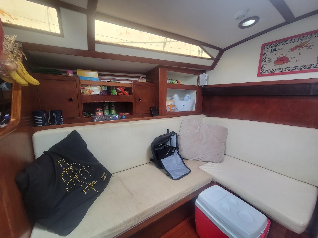 Cozy interior of 1984 Moody 419 sailboat with seating, storage, and decor.