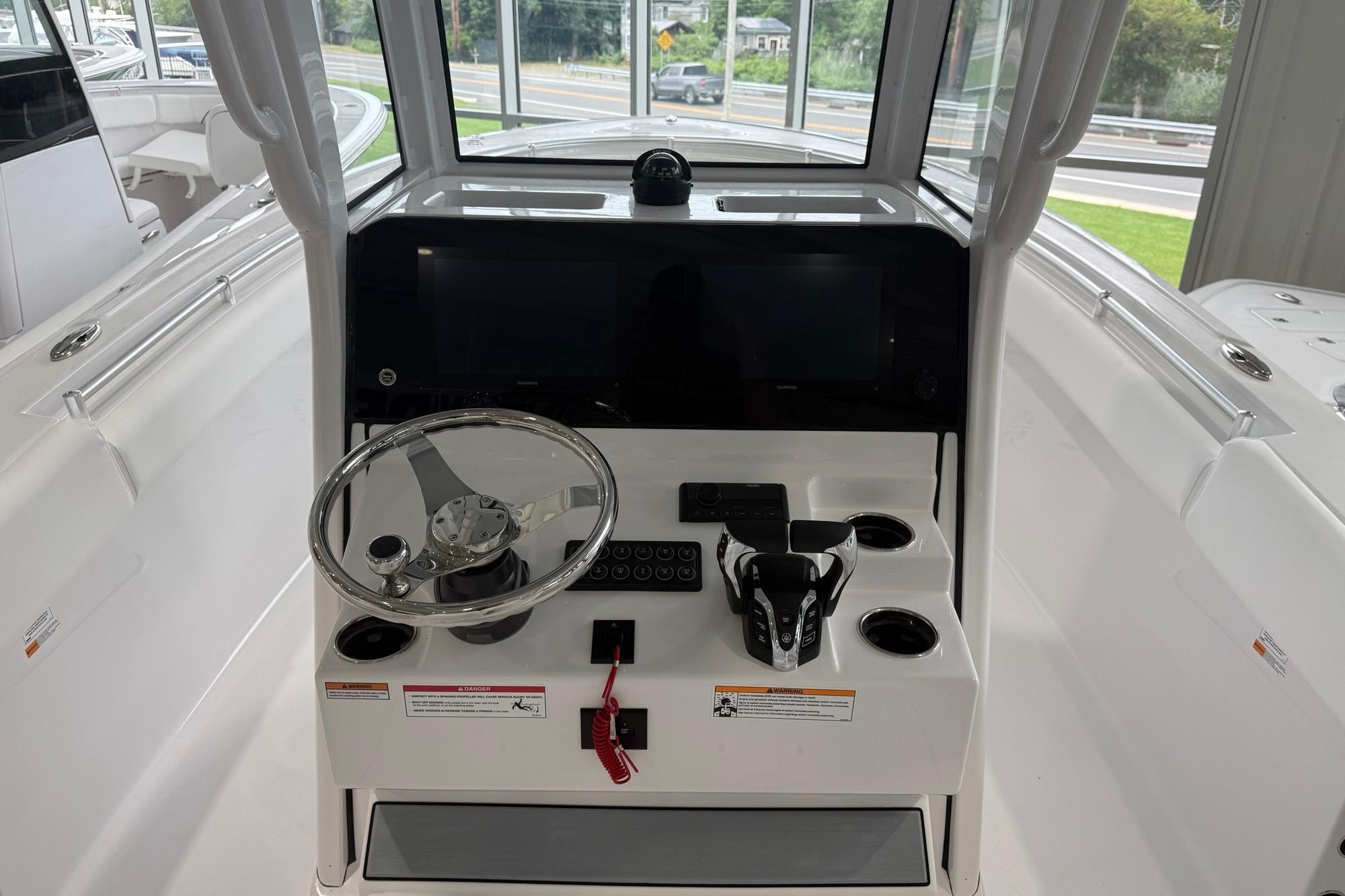 2026 Sportsman Open 252 Center Console boat interior with steering wheel and control panel.