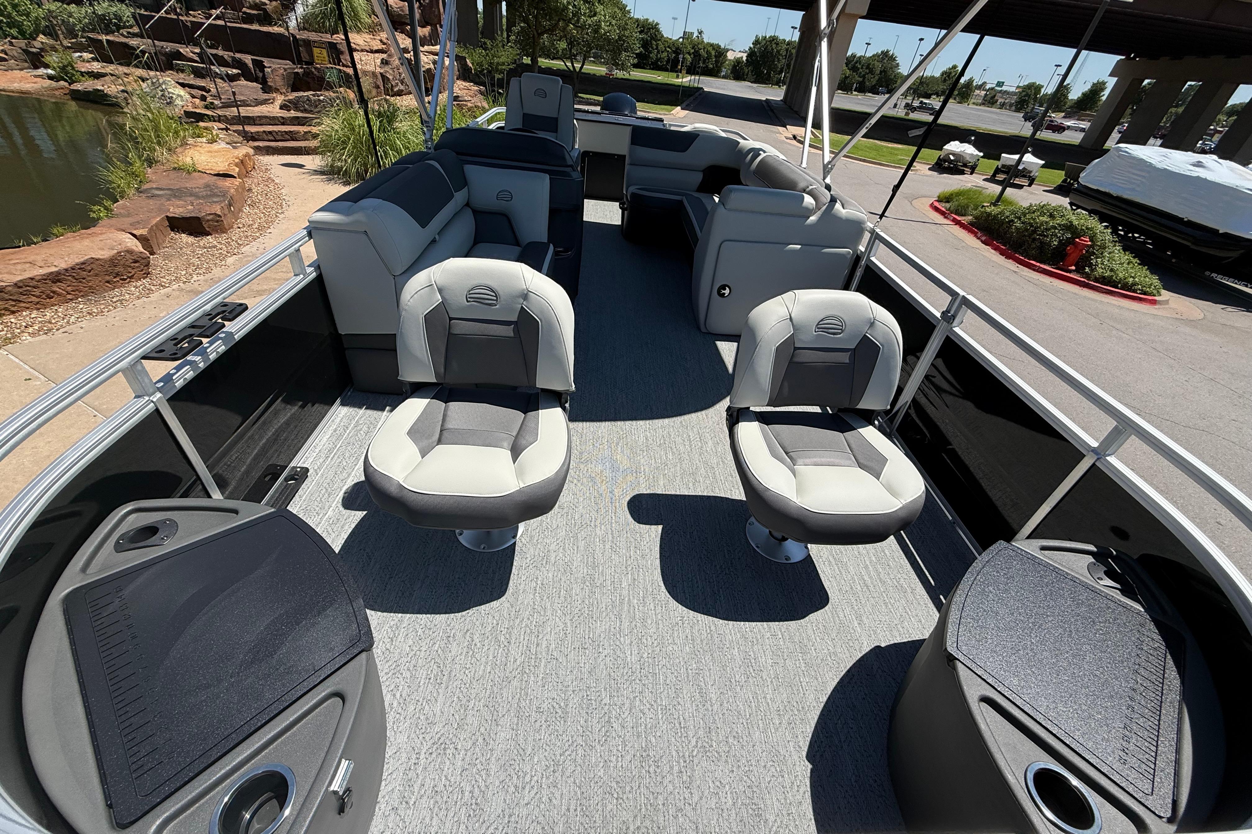2026 Sun Tracker Fishin' Barge 22 DLX interior with seating and fishing amenities.