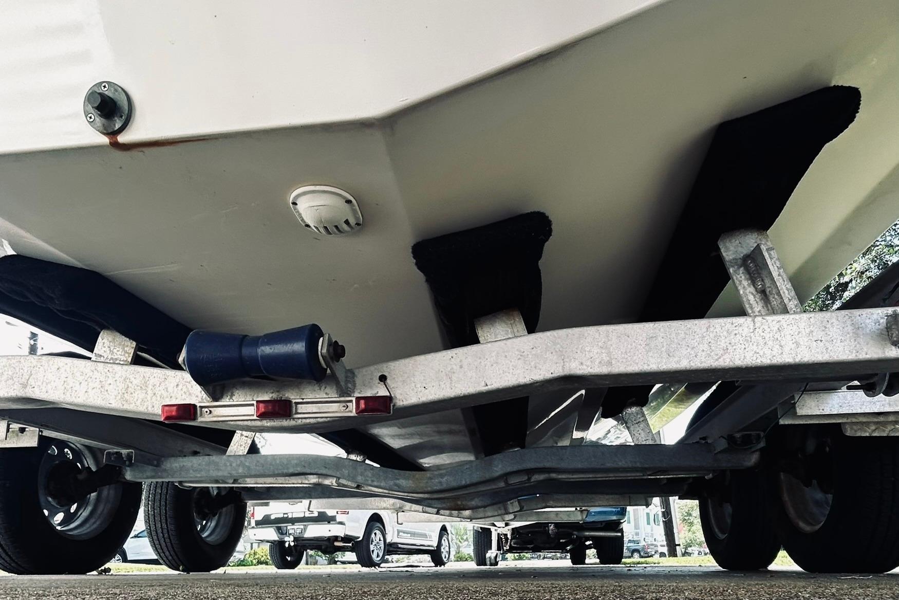 Underneath view of a 2013 Hurricane SunDeck Sport 201 OB boat on a trailer.