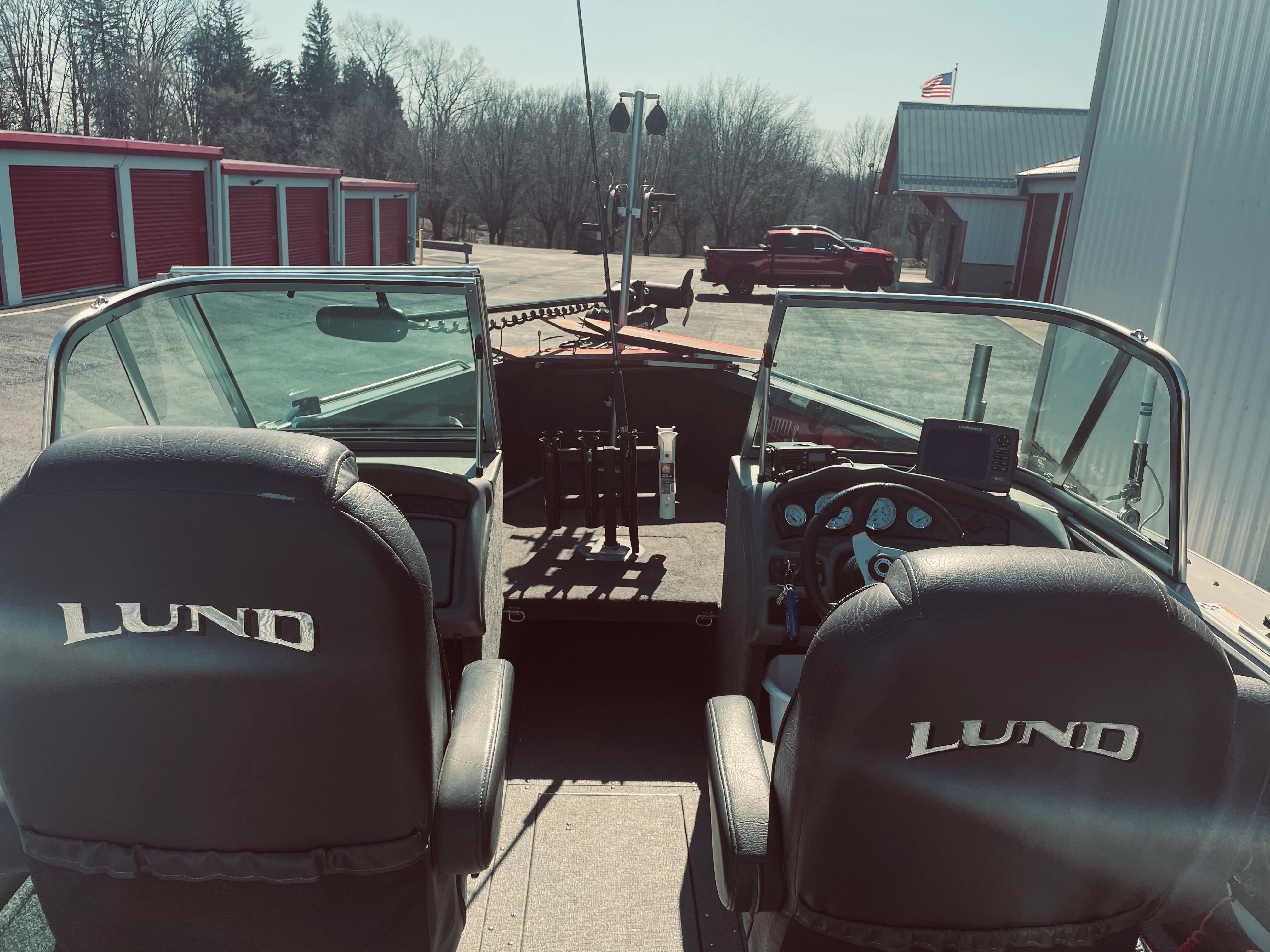 Interior view of a 2012 Lund Baron boat with two seats and a steering console.