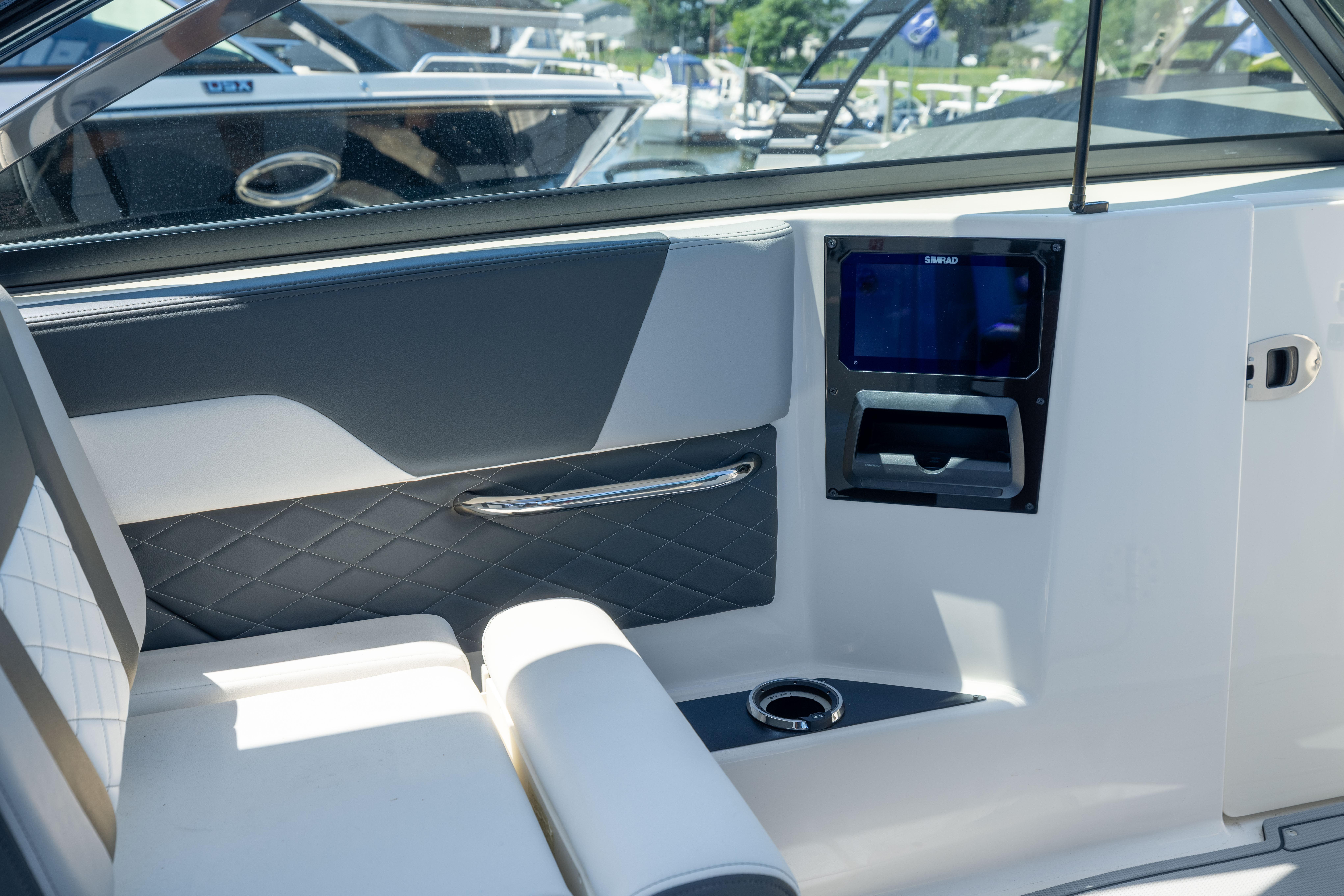 Interior of 2026 Chaparral 310 OSX boat with modern seating and control panel.