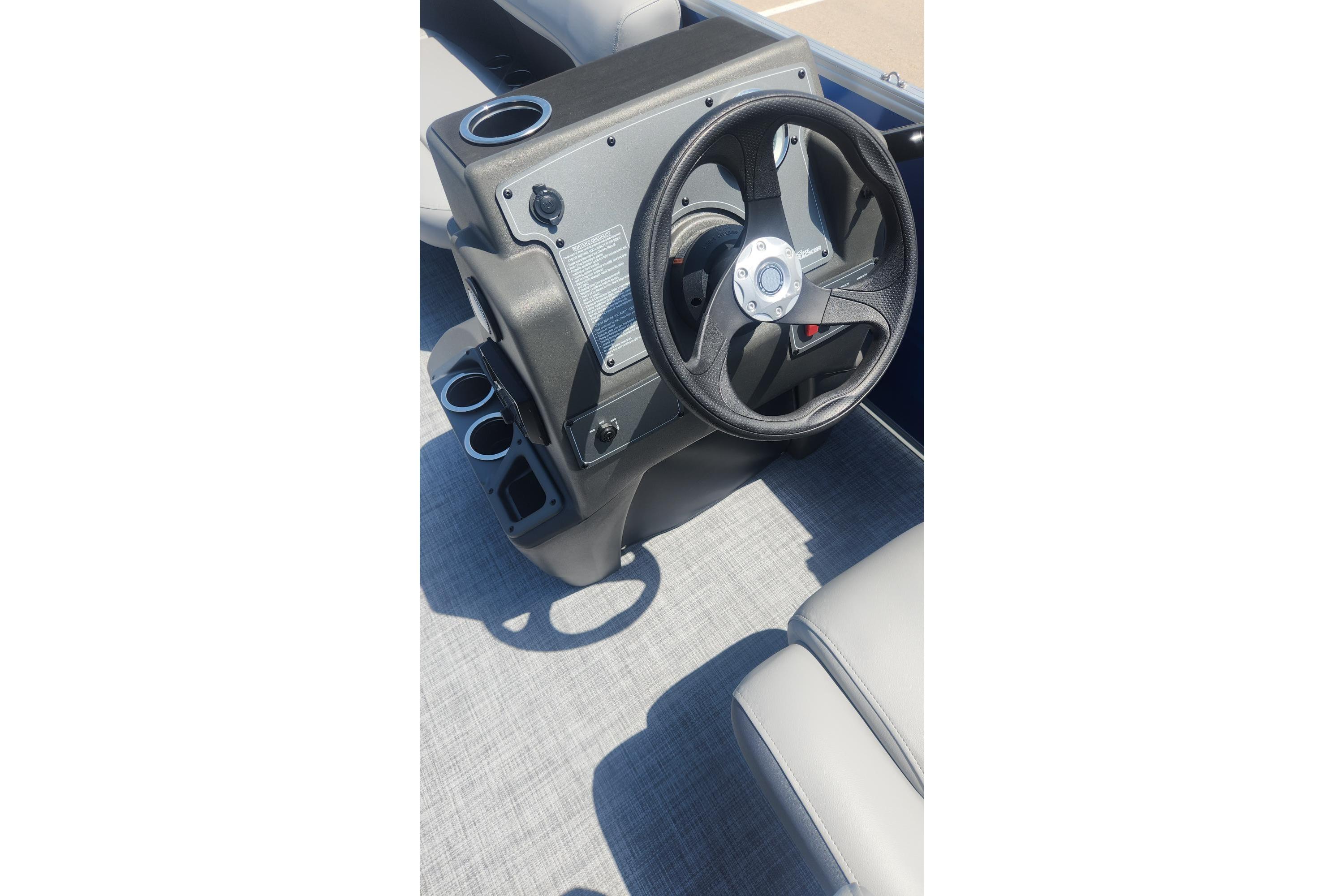 Steering console of 2026 Sun Tracker Party Barge 16 DLX pontoon boat.