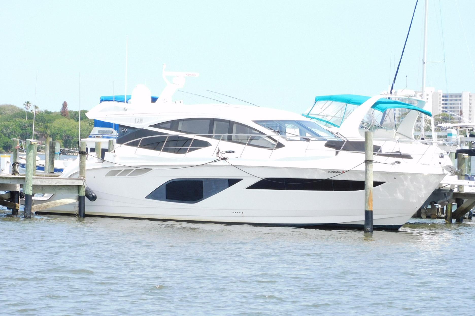 2019 Sea Ray L550 yacht docked at marina, featuring sleek design and modern amenities.