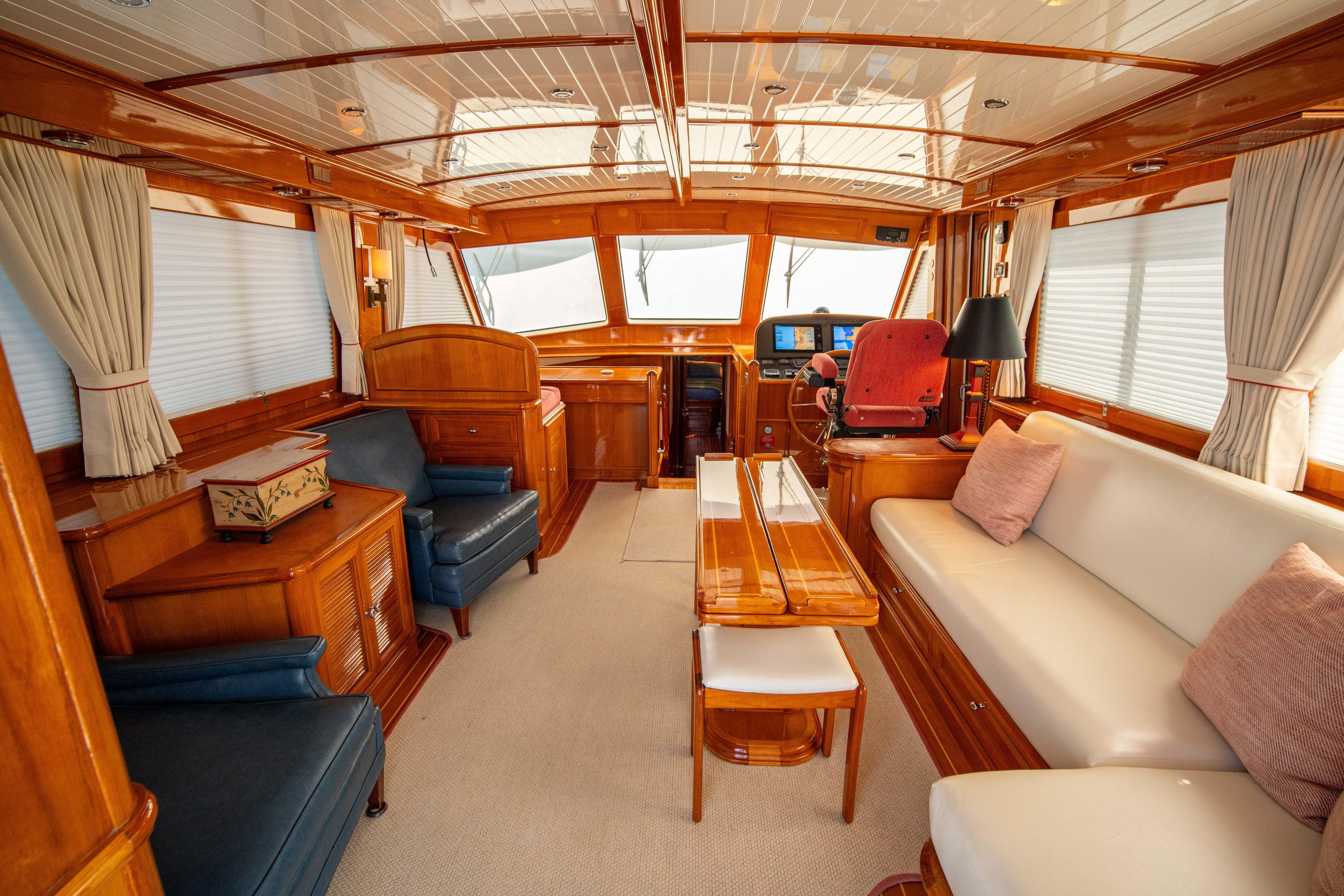 Luxurious interior of 2004 Grand Banks 58 Eastbay FB yacht, featuring elegant wood finishes.