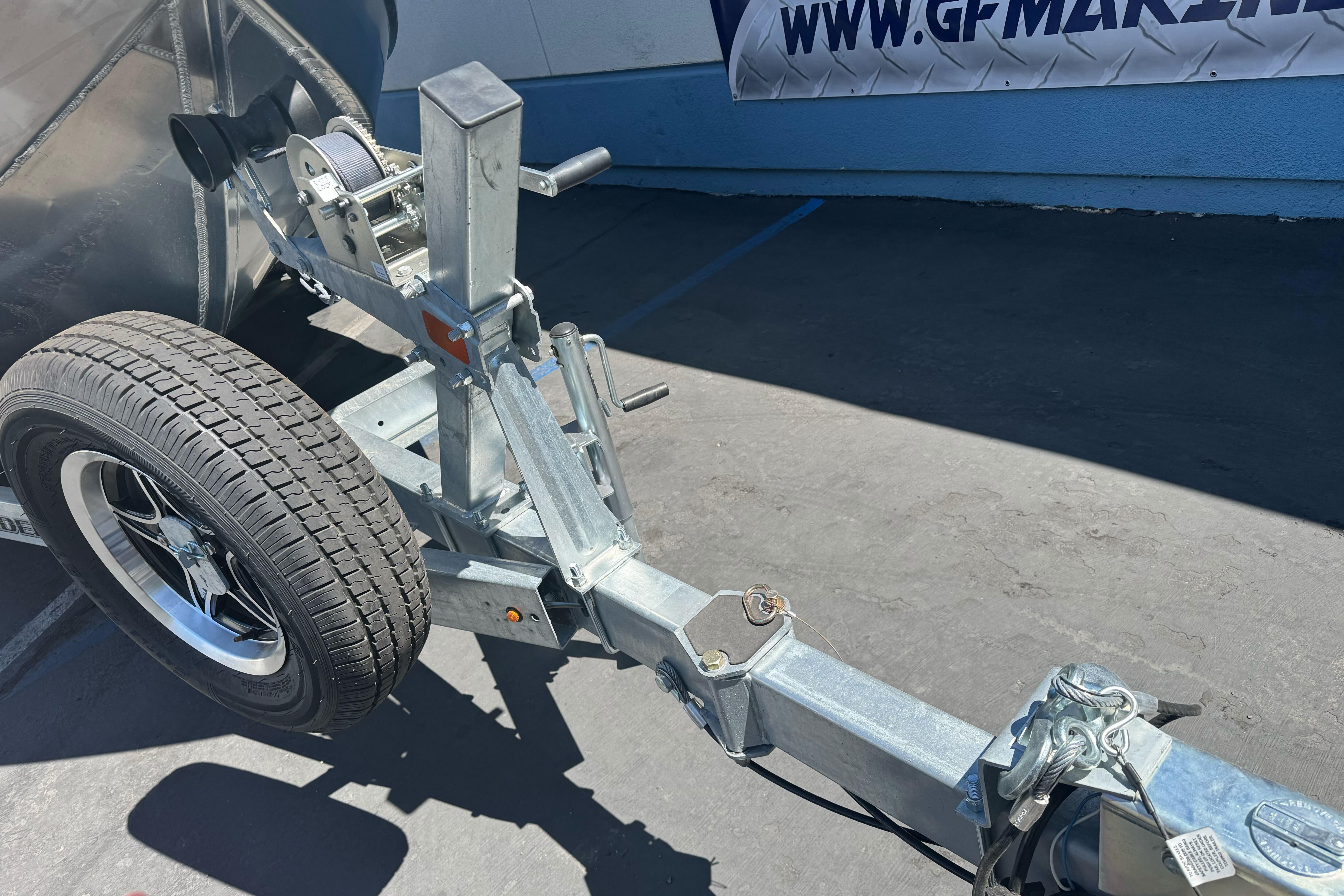 Trailer hitch of a 2026 Lund 210 Heavy Gauge boat, featuring a sturdy wheel and winch.
