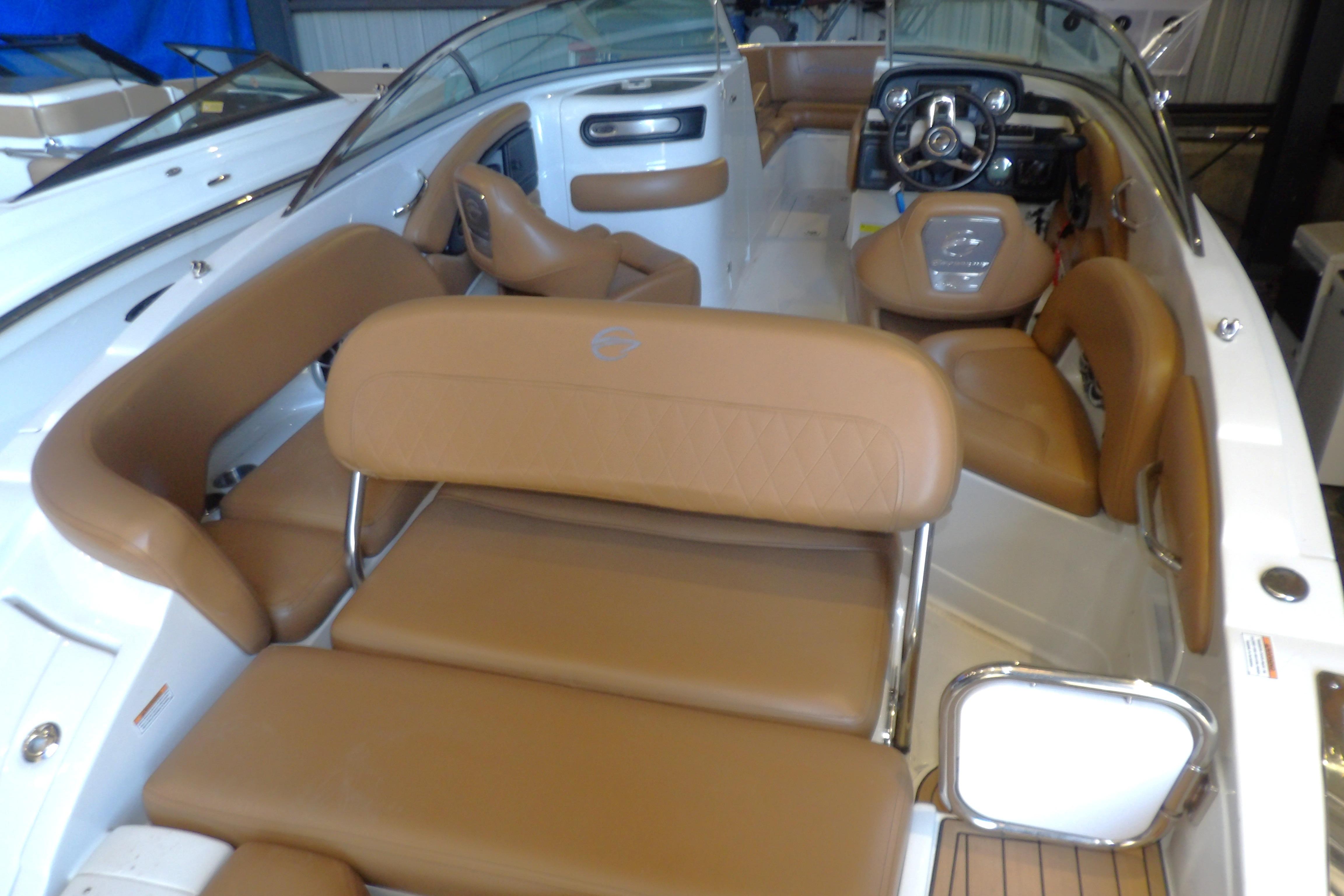 2023 Crownline 250 XSS boat interior with tan leather seating and modern dashboard.
