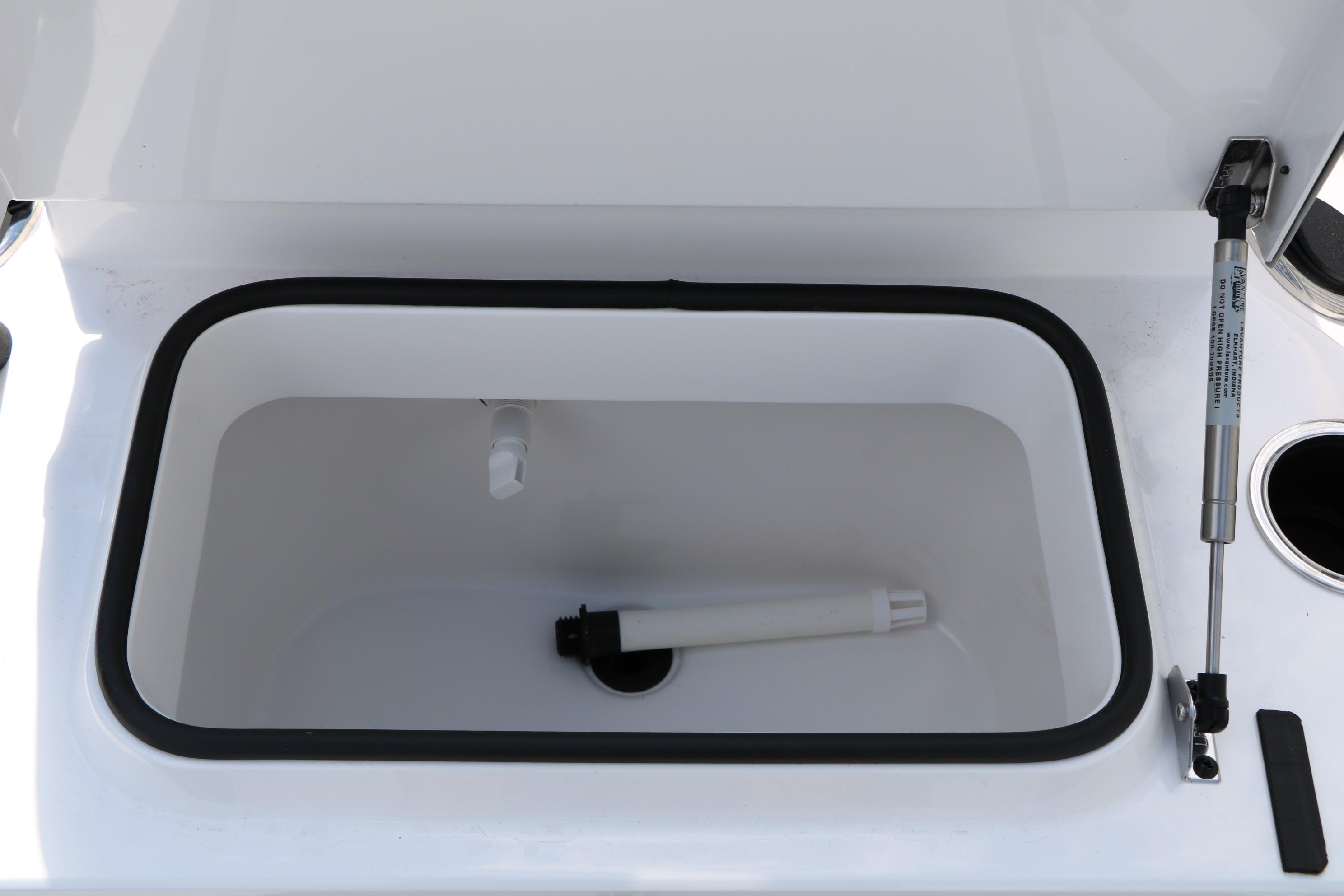 Livewell compartment in 2026 Vexus Defender 201 boat, featuring hydraulic lift support.