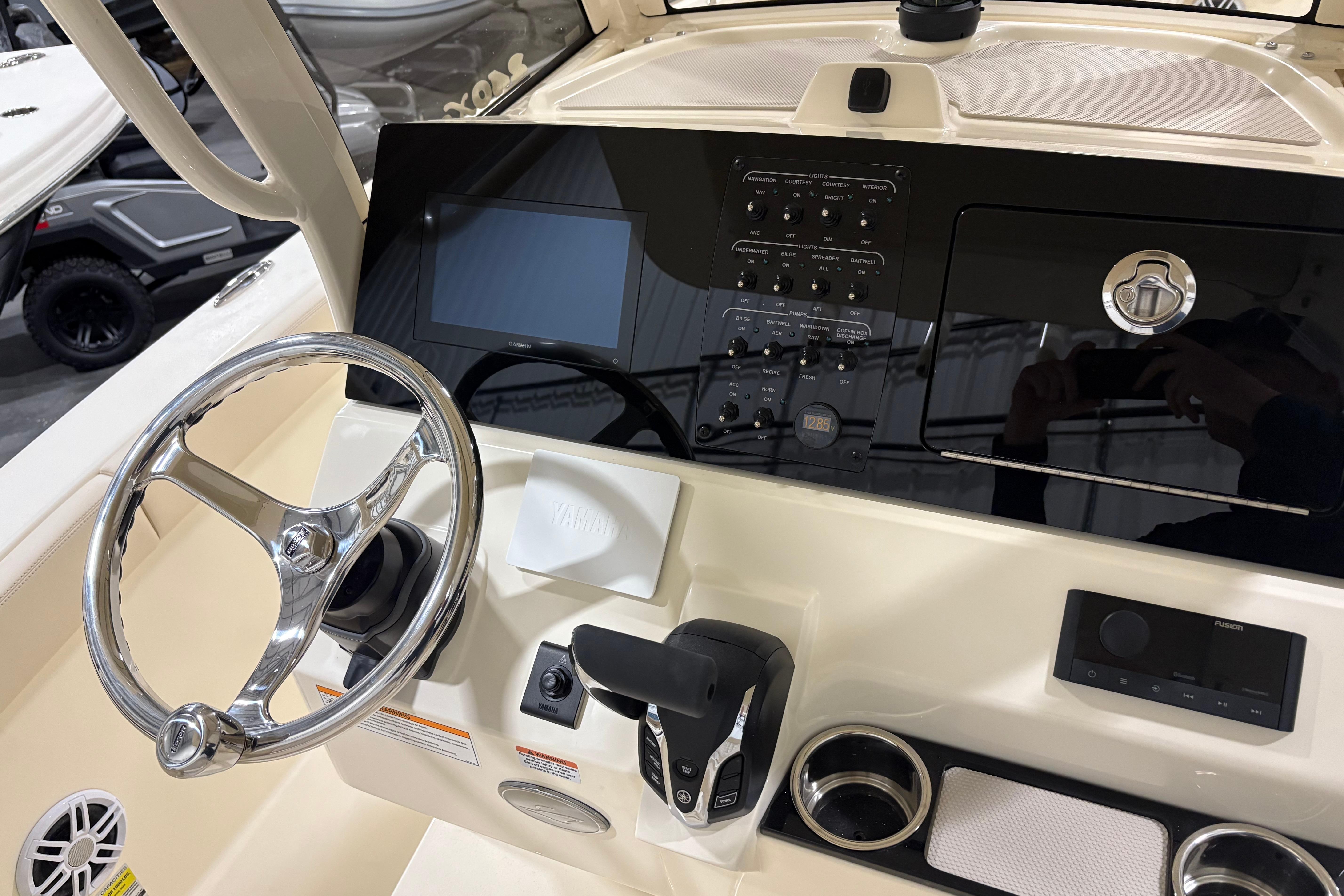 2026 Scout 240 XSF boat dashboard with steering wheel and control panel.
