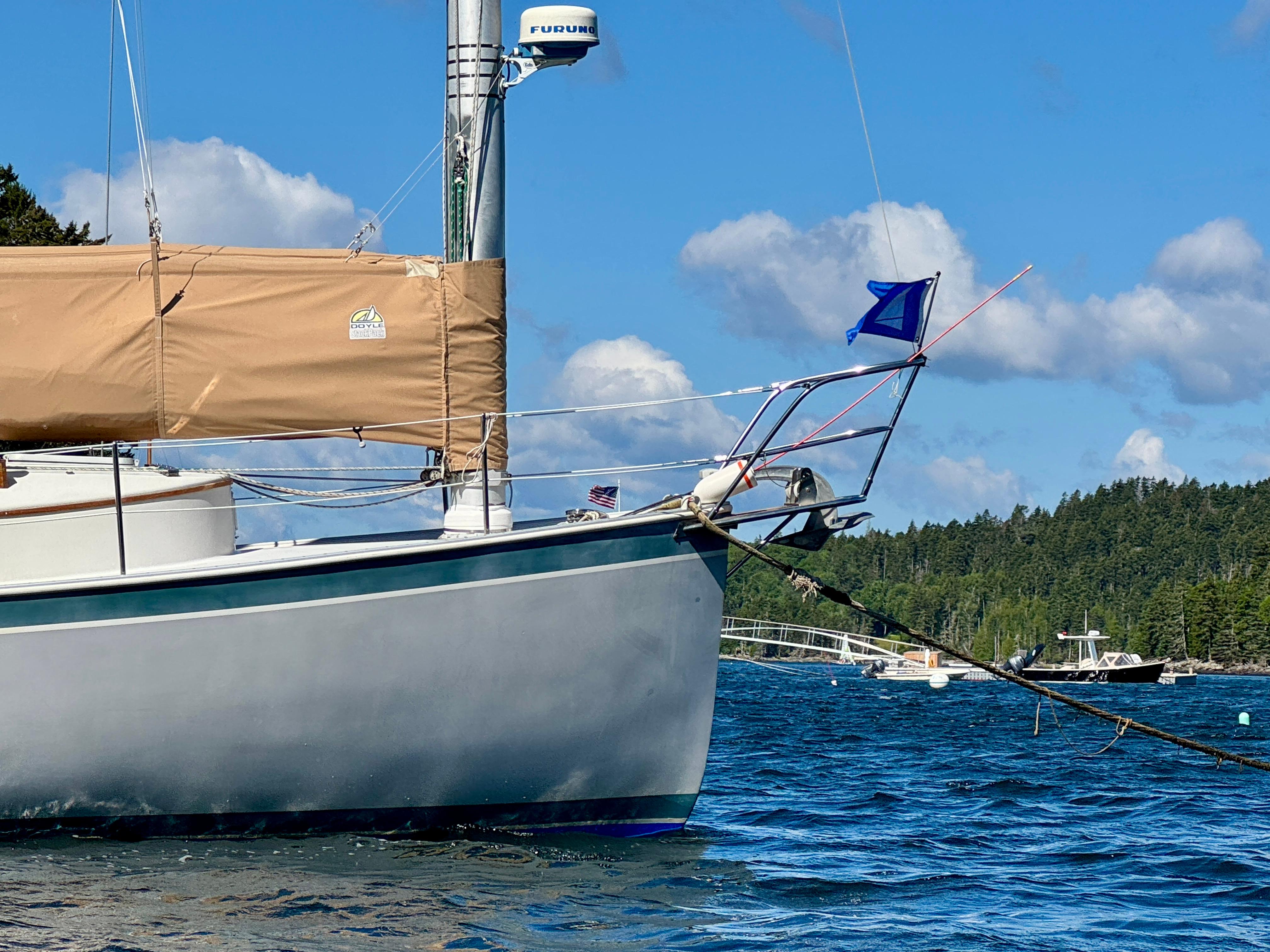 Sailboat Nonsuch 30 Ultra, 1989 model, anchored on a sunny day with blue skies.
