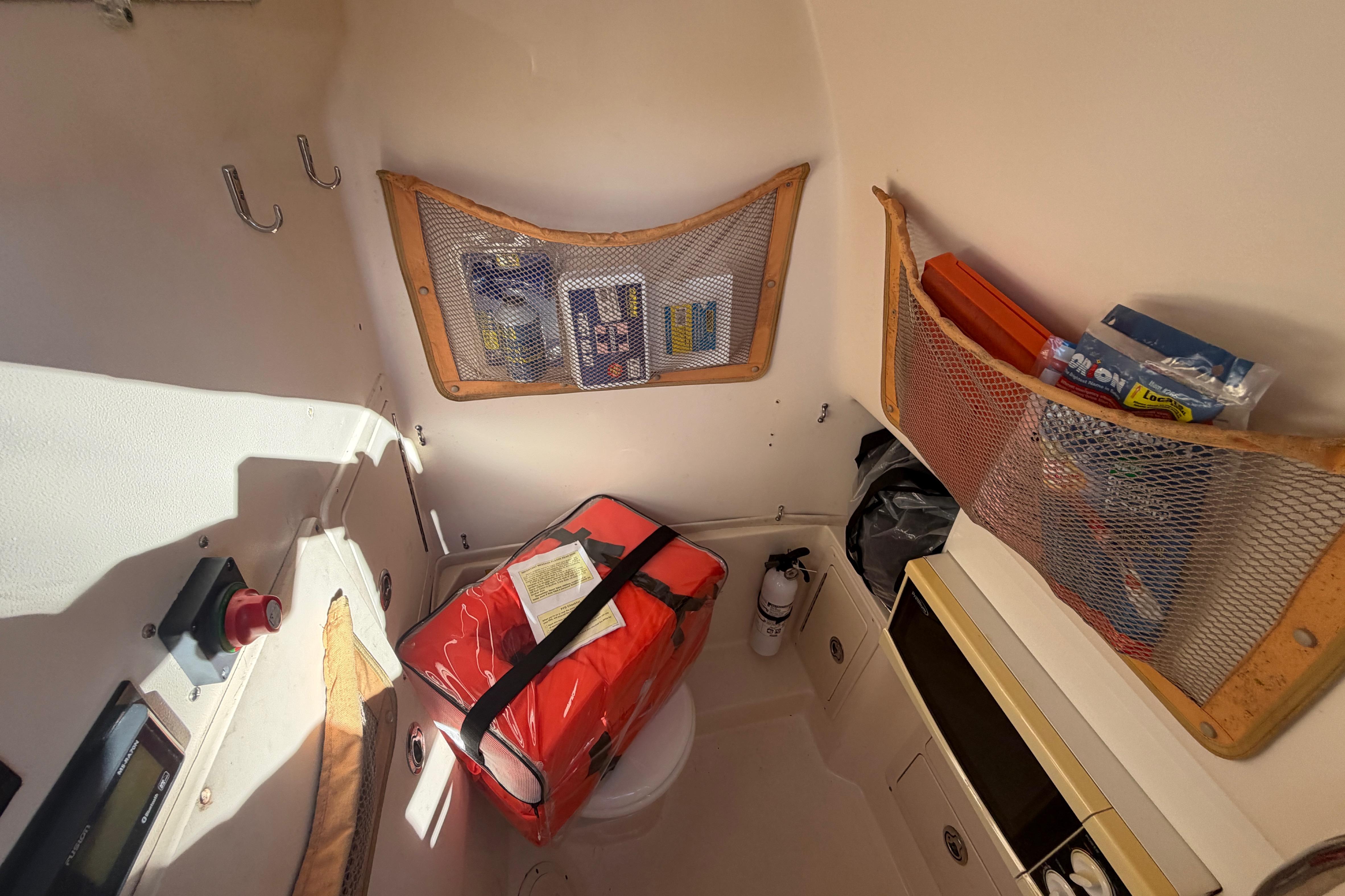 Interior of 2004 Grady White 273 boat with storage nets and safety equipment.