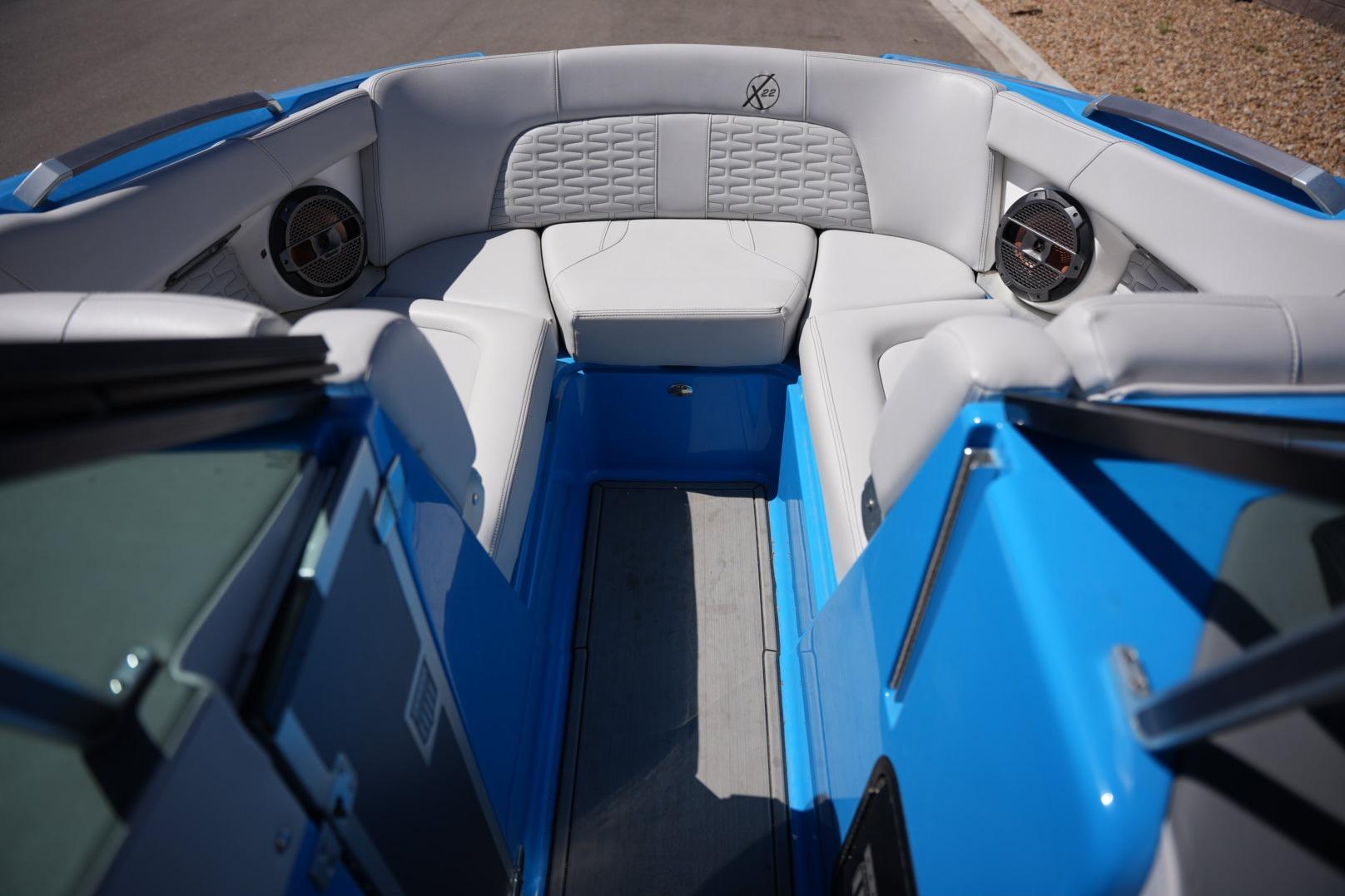 2020 MasterCraft X22 boat interior with blue and gray seating, featuring premium speakers.