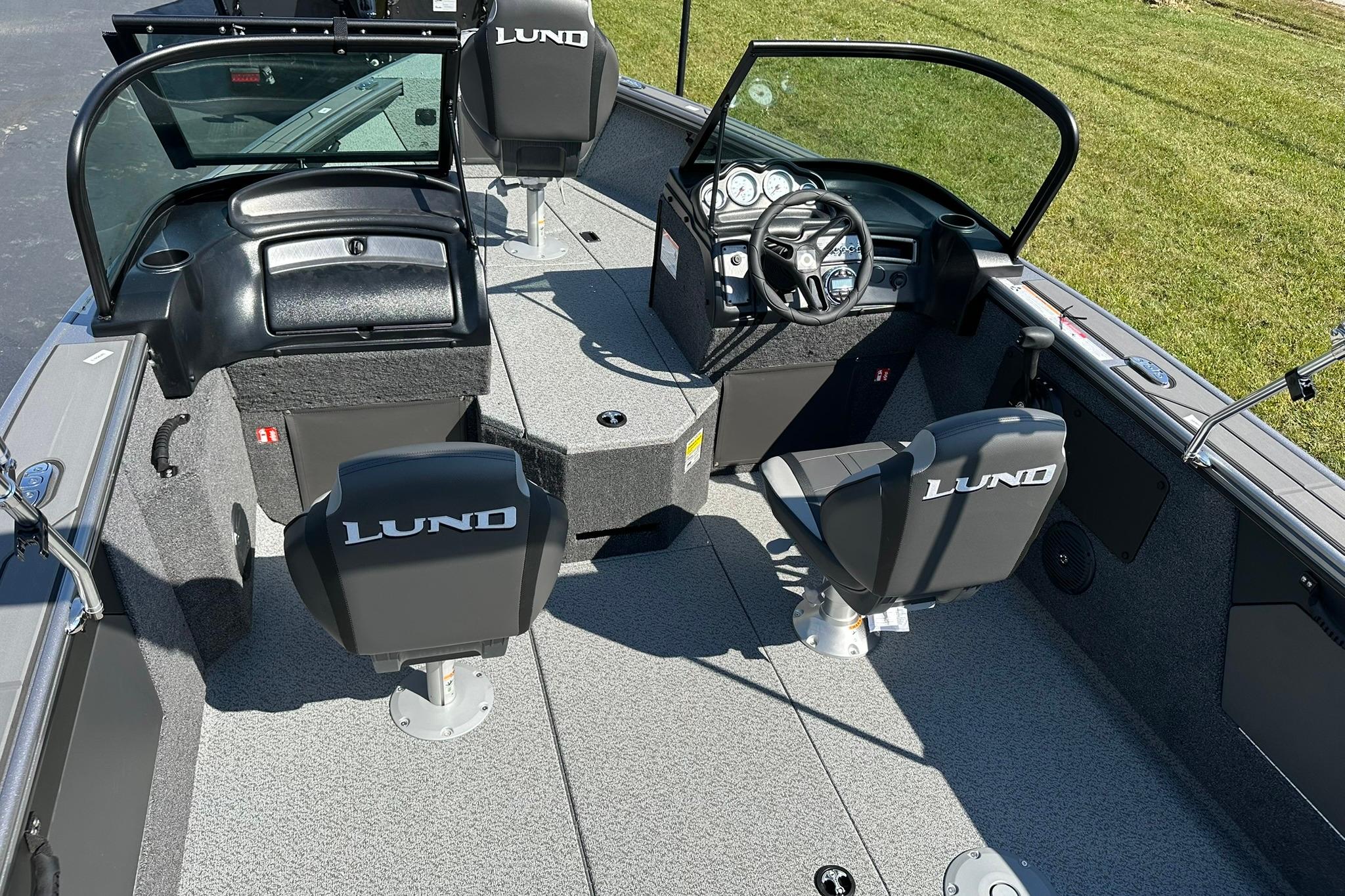 2026 Lund 1875 Fisherman boat interior with steering wheel and seating.
