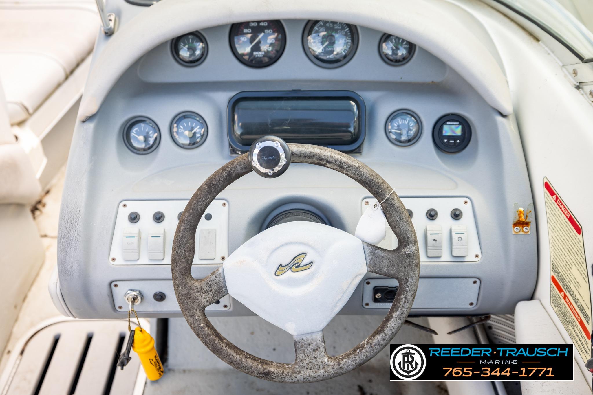 1996 Sea Ray 210 Bow Rider dashboard with steering wheel and instrument panel.