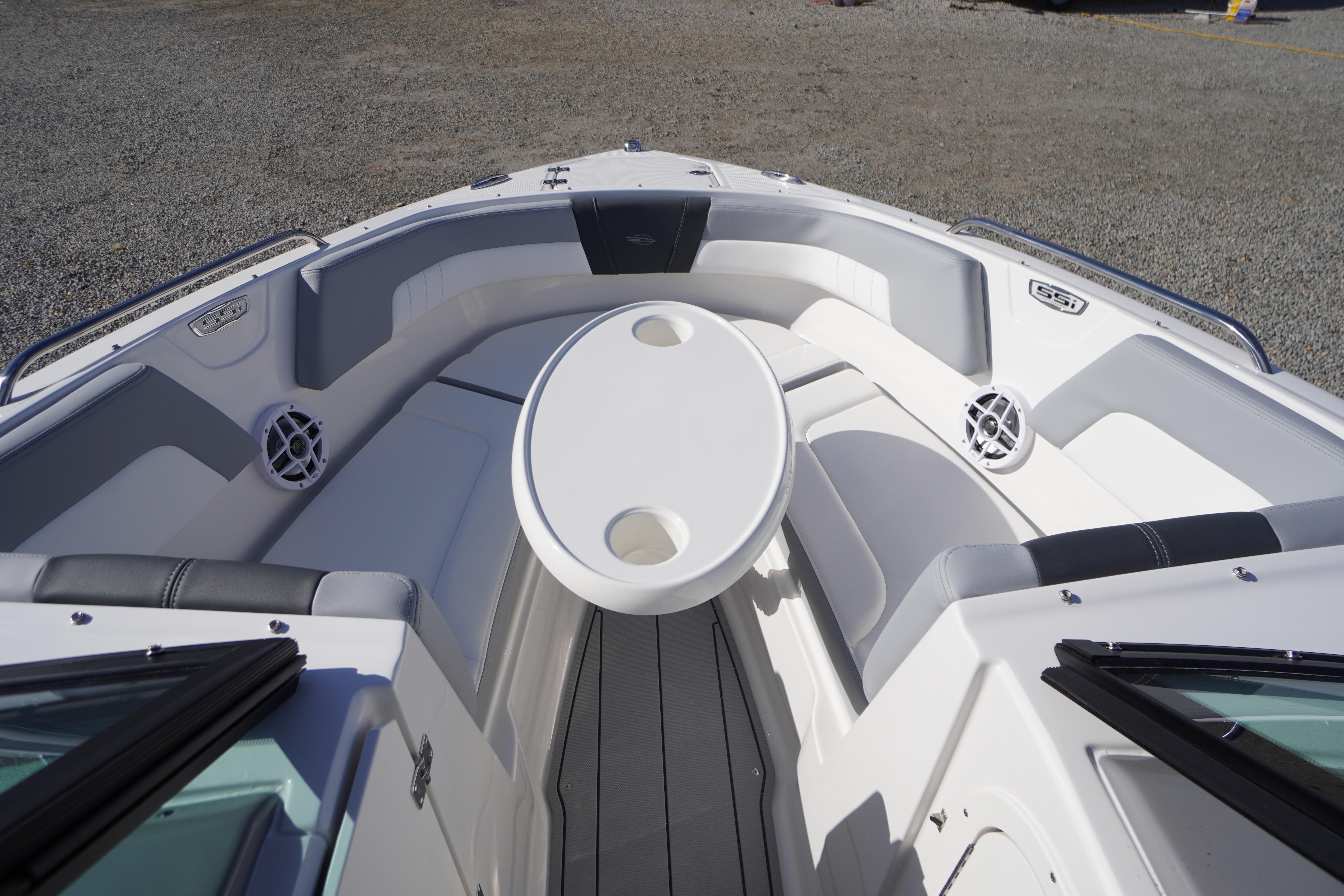 2026 Chaparral 23 SSi OB boat interior with seating and table, showcasing modern design.