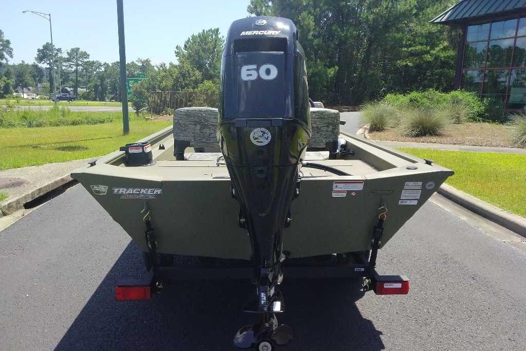 2026 Tracker Grizzly 1754 SC boat with Mercury 60 engine, parked outdoors.