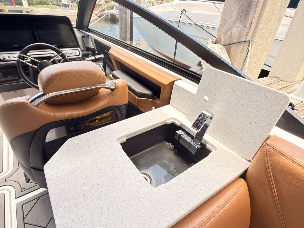 The image shows the cockpit of a 2024 Cobalt R8 Outboard with a sink.