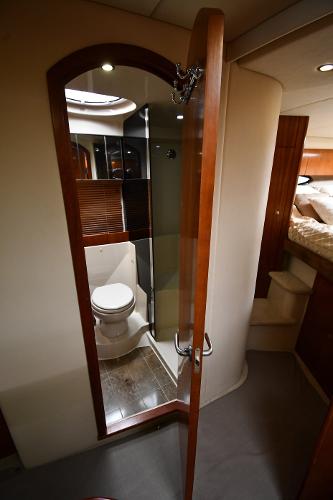 2010 Cruisers Yachts 390 Sports Coupe bathroom interior with wooden door and modern fixtures.