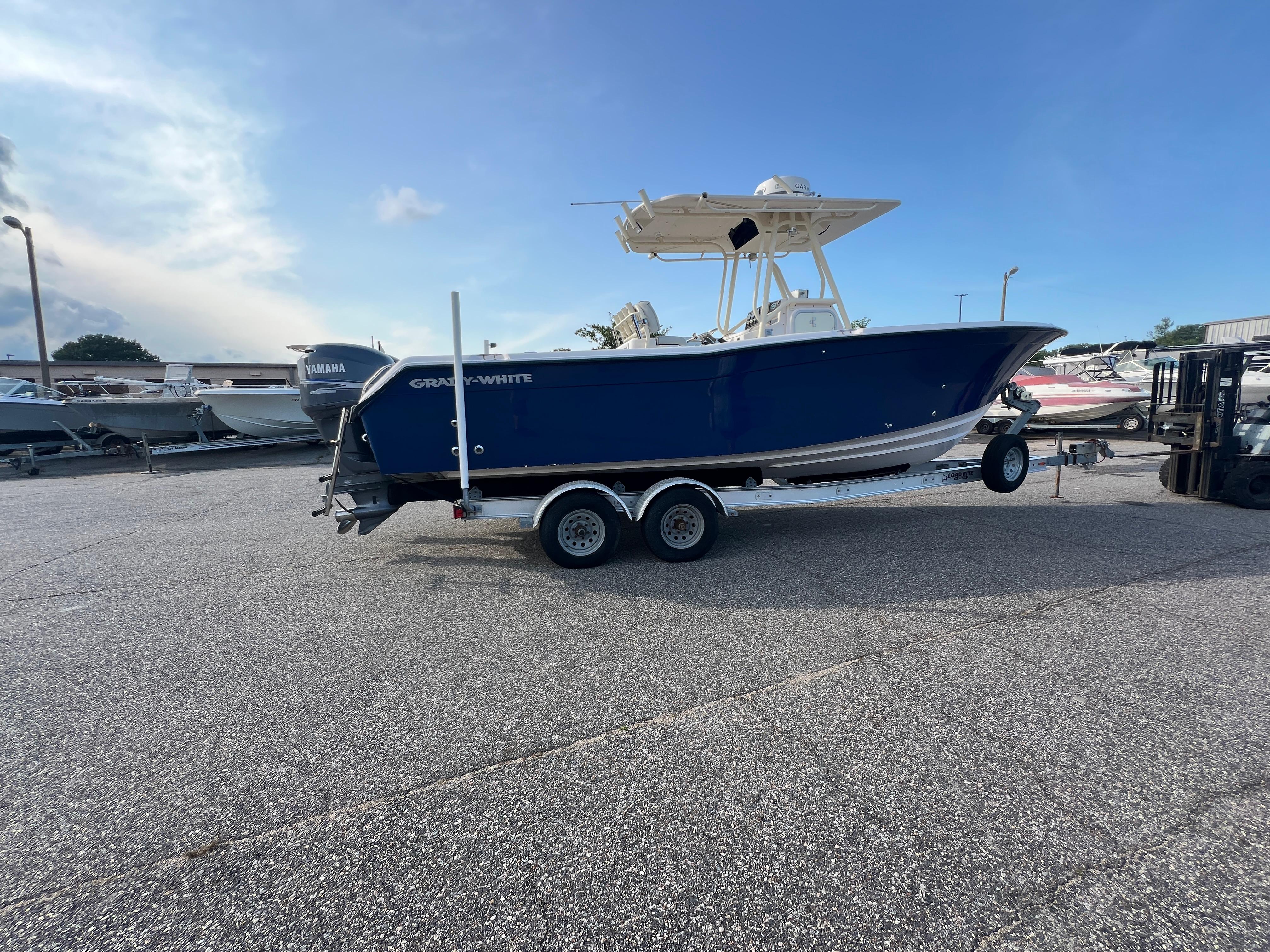 2002 Grady-White Chase 273 boat on trailer in parking lot, side view.