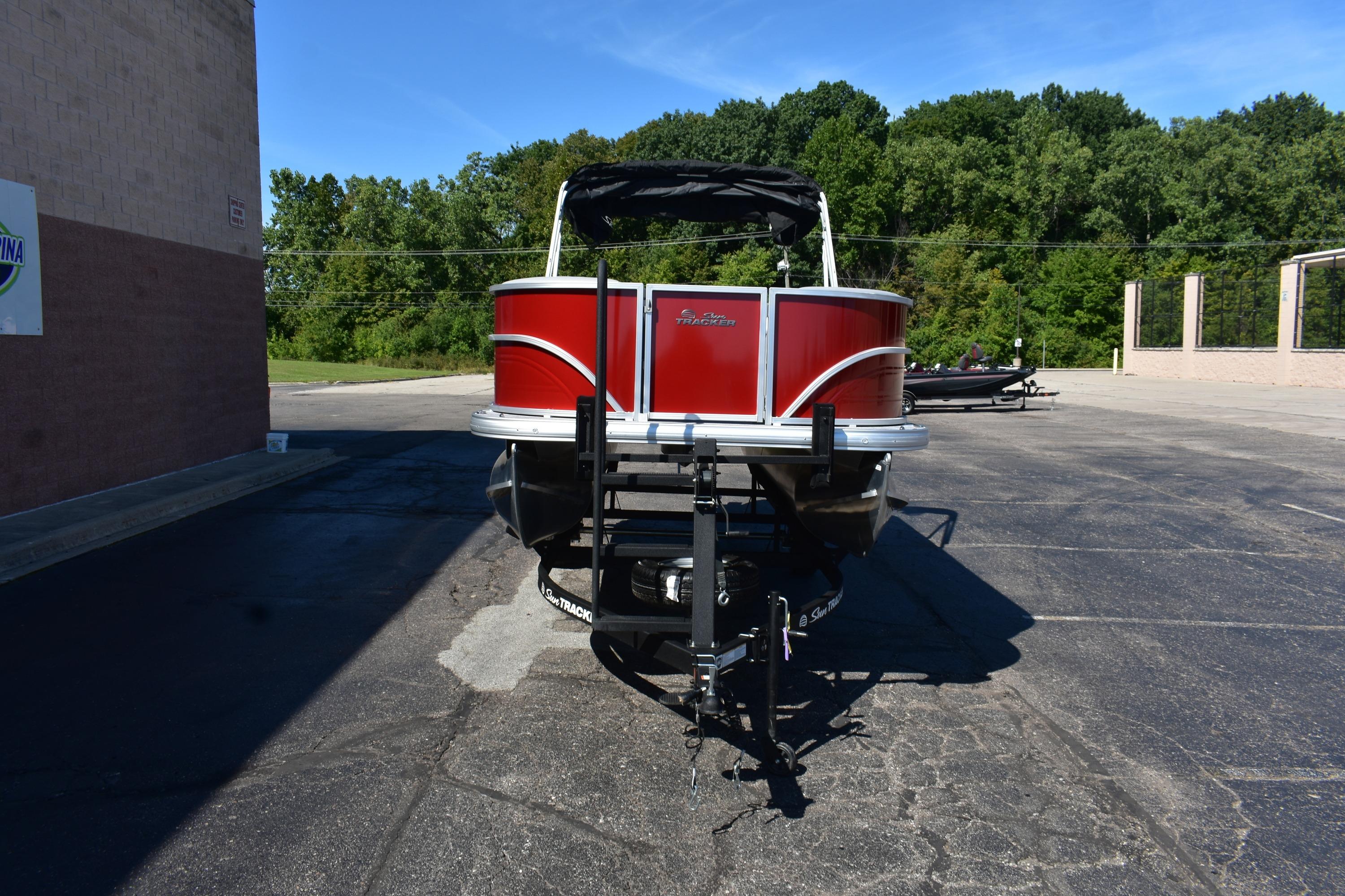 2026 Sun Tracker Party Barge 18 DLX pontoon boat in parking lot, front view.
