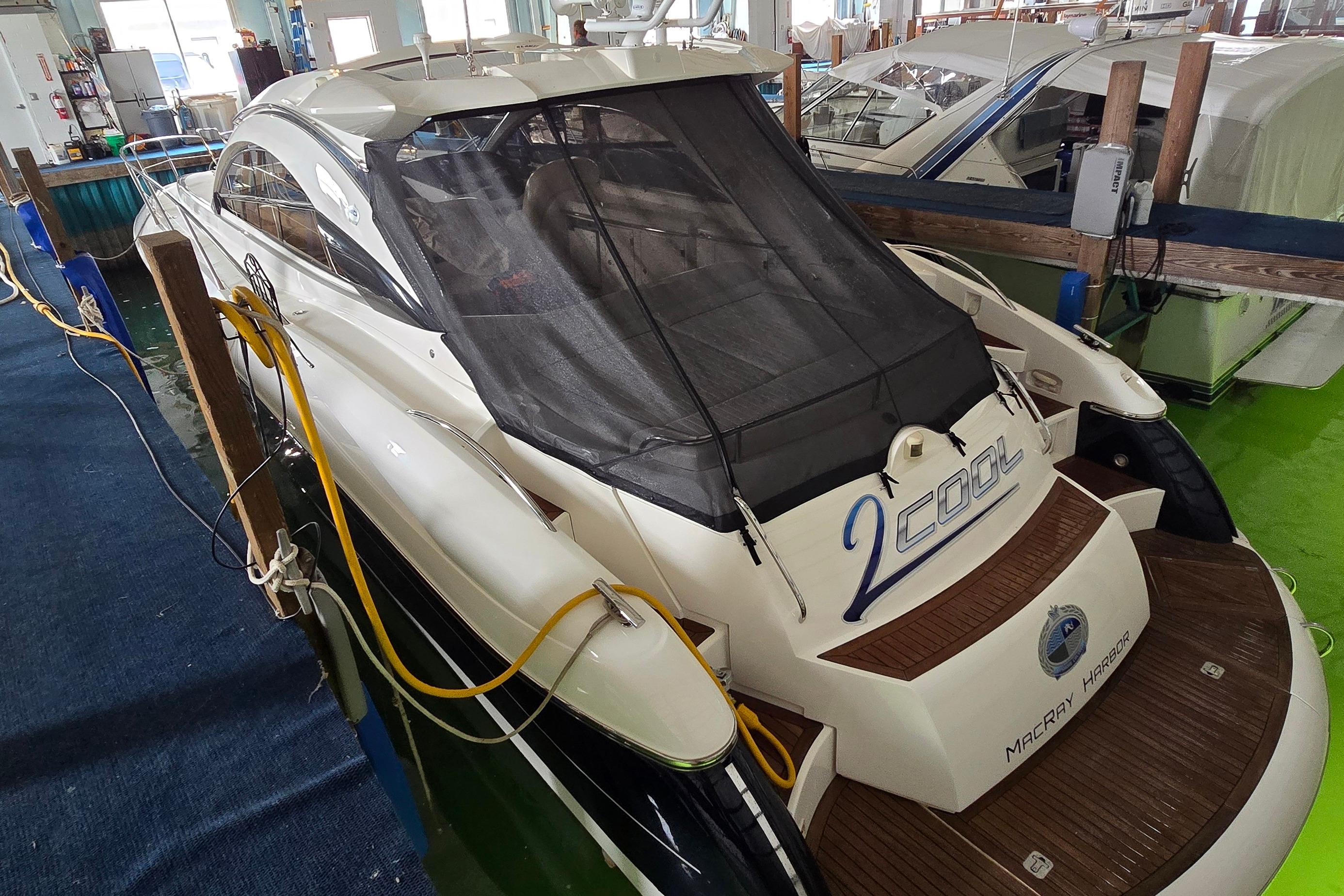 2004 Sunseeker Camargue 50 yacht docked indoors, rear view with protective cover.