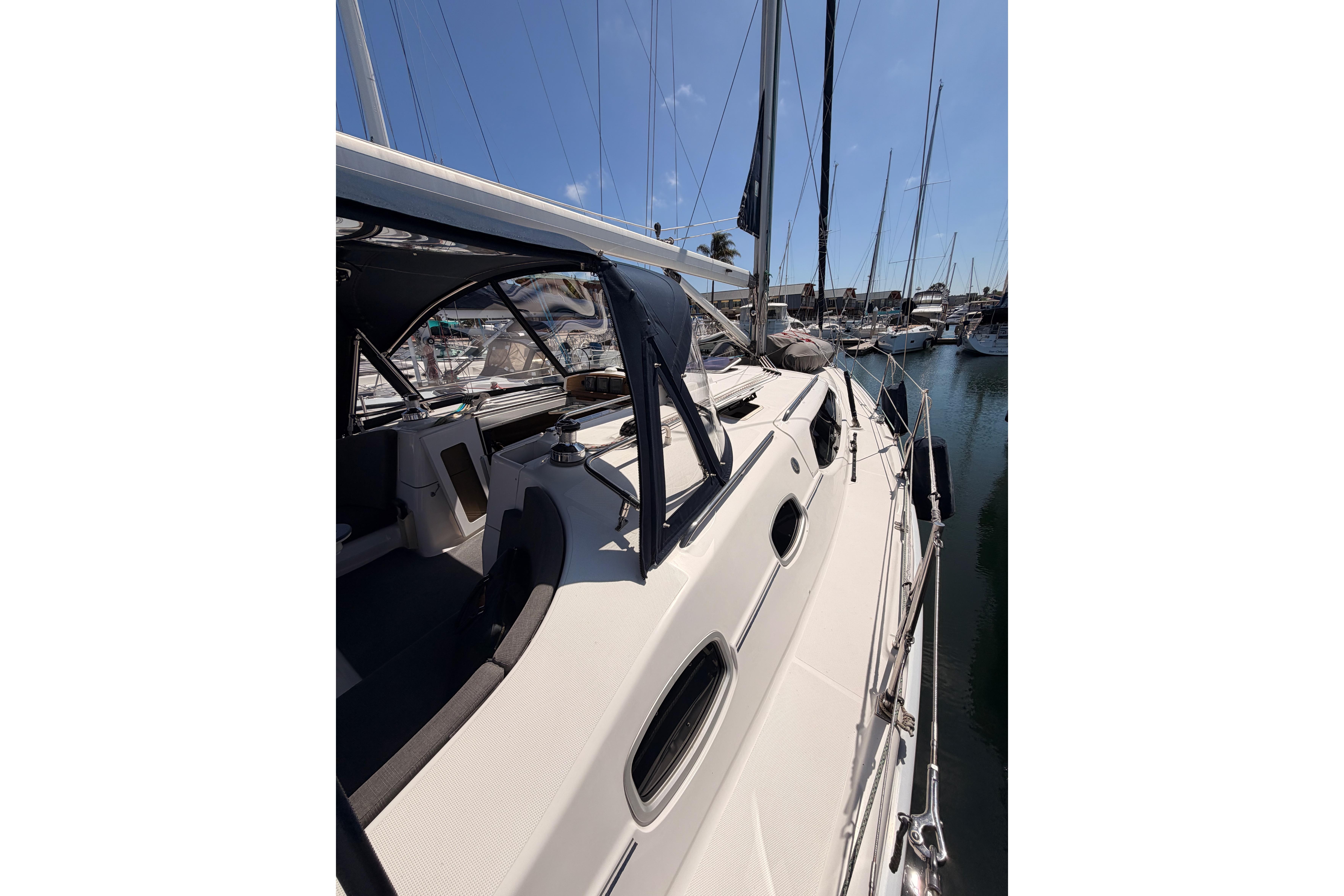 2008 Hunter 45 Deck Salon sailboat docked in a marina under clear blue skies.