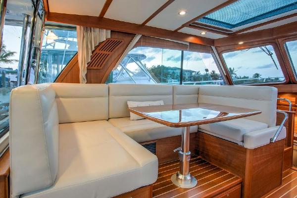 Interior of the 2027 Sabre 38 Salon Express with elegant seating area and wood finish.
