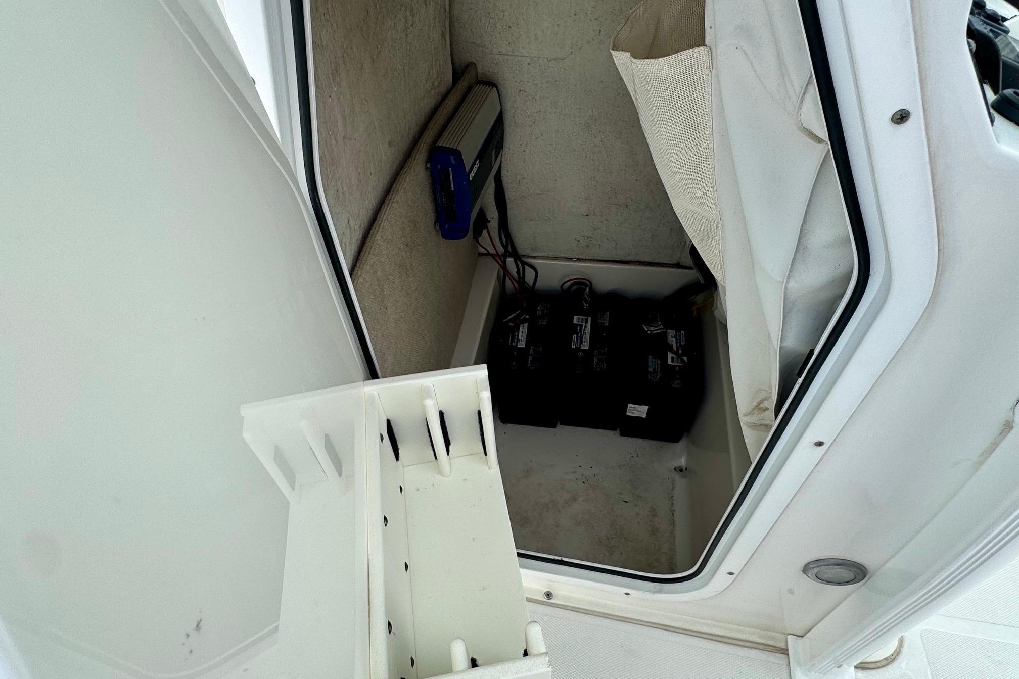 2015 Sea Hunt Ultra 234 boat storage compartment with batteries and equipment.