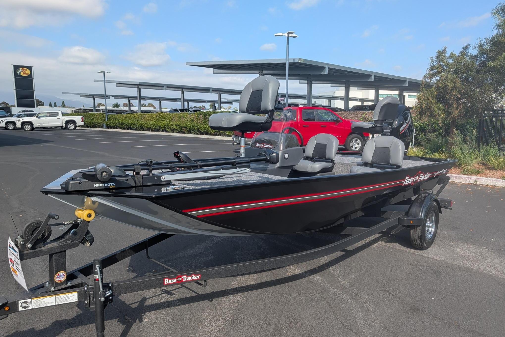 2026 Tracker Bass Tracker Classic XL fishing boat on trailer in parking lot.