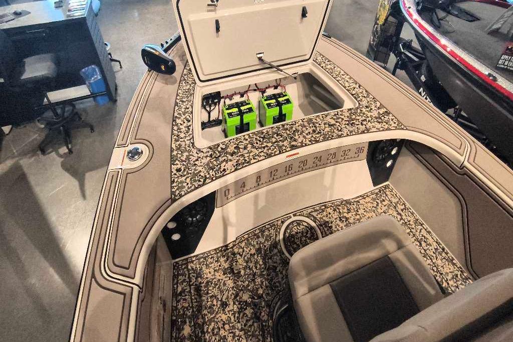 2026 Mako 18 Pro Skiff Backwater Edition boat interior with storage compartment and batteries.