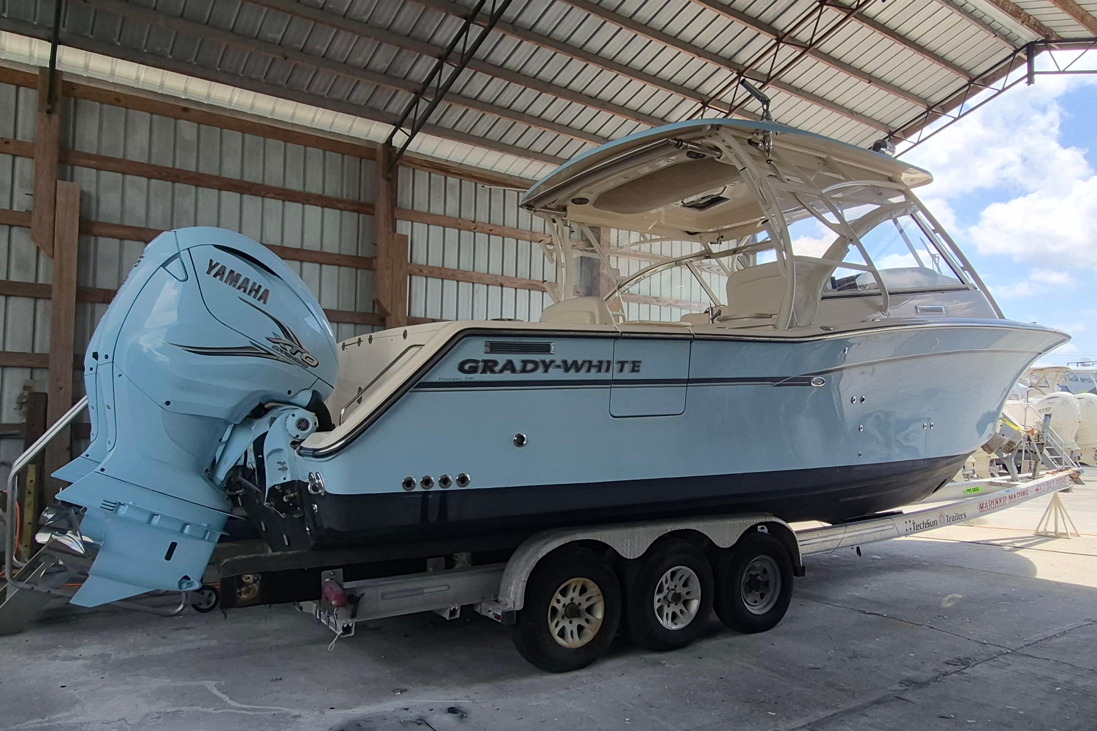 2019 Grady-White Freedom 335 boat with Yamaha engine on a trailer in a covered area.