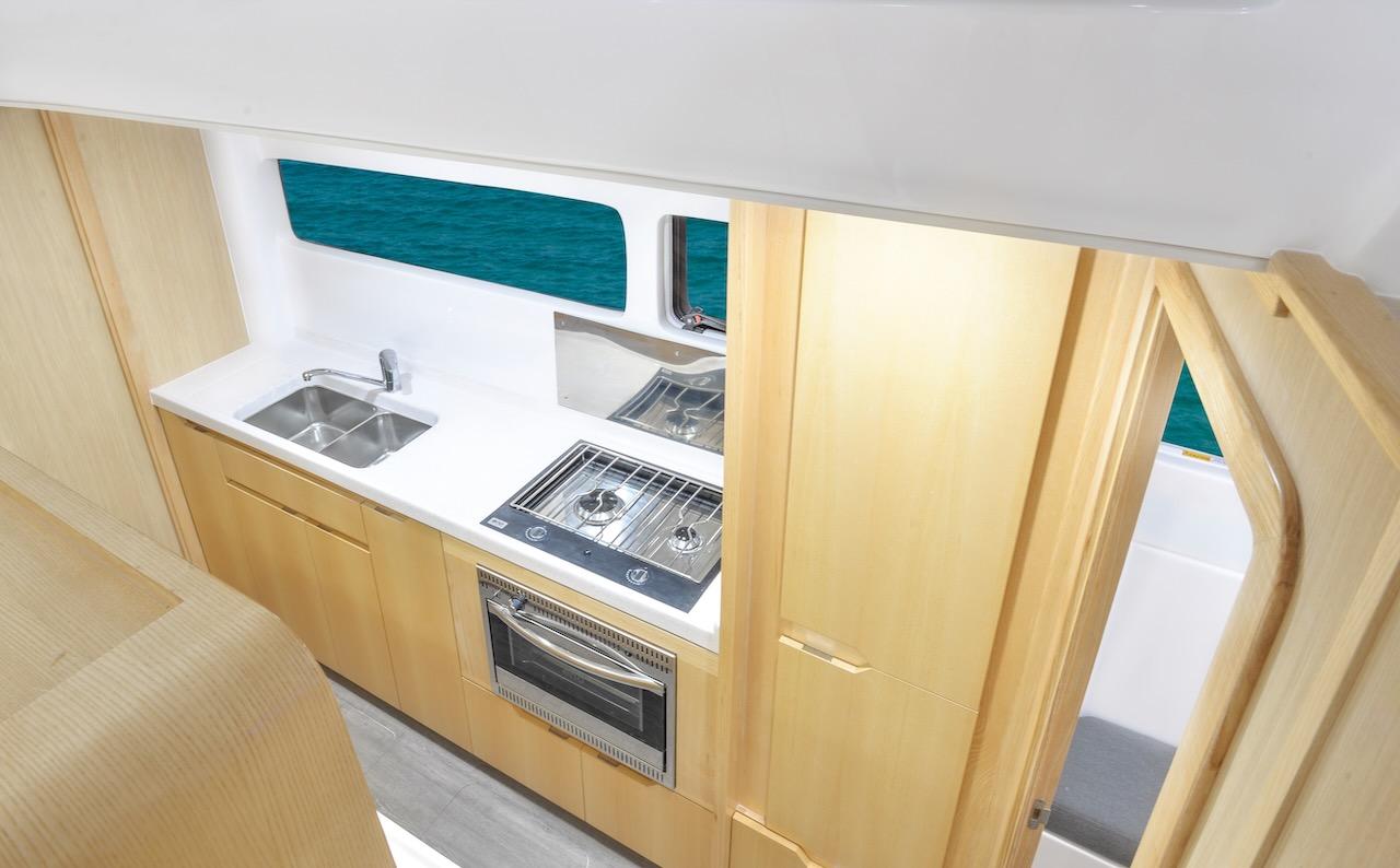 Modern kitchen interior of 2025 Seawind 1170 yacht with ocean view.