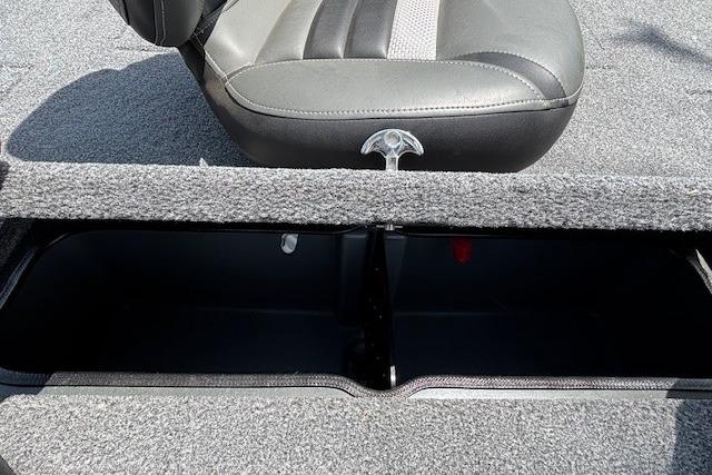 2026 Ranger RT188 boat storage compartment with cushioned seat and carpeted interior.