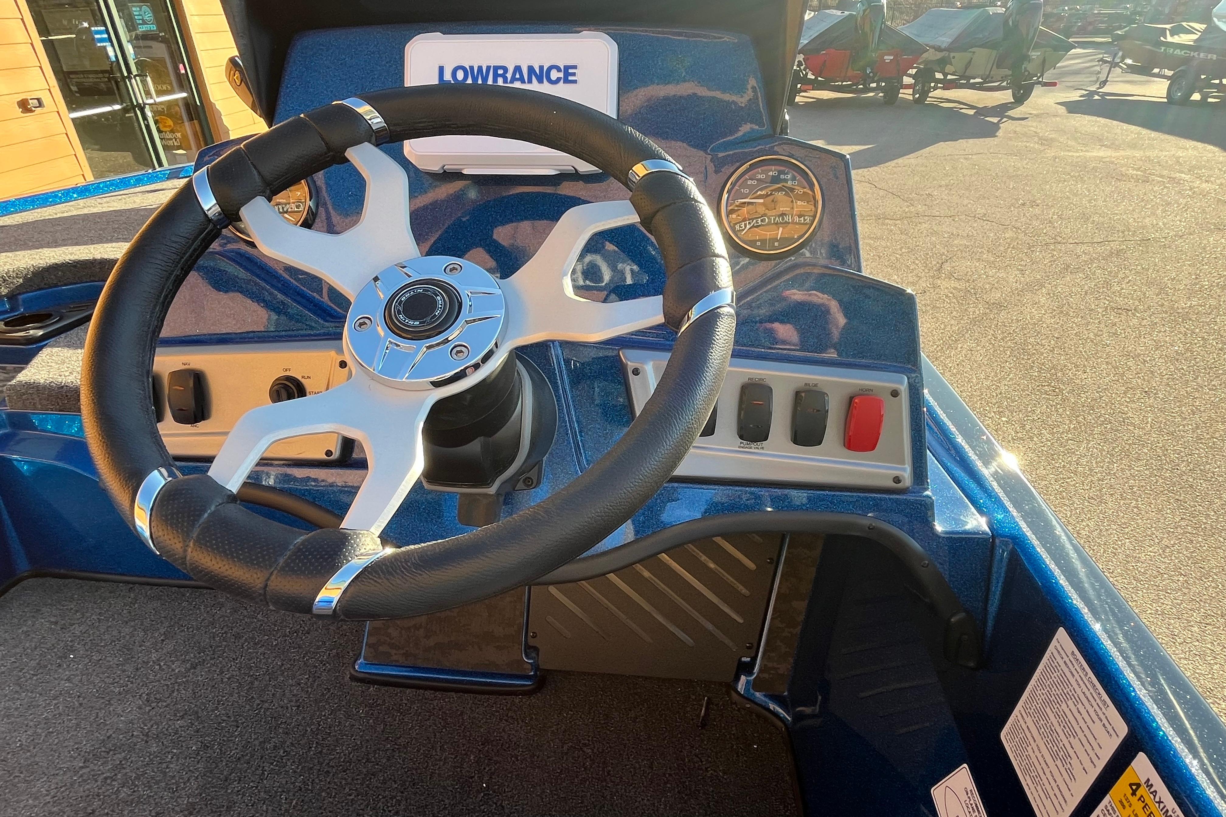 Steering wheel and dashboard of 2026 Nitro Z19 XL boat in sunlight.