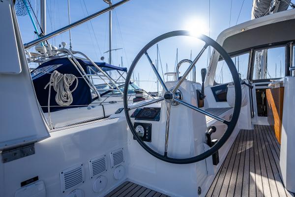 Beneteau Oceanis 38.1, 2021, steering wheel in sunlight.