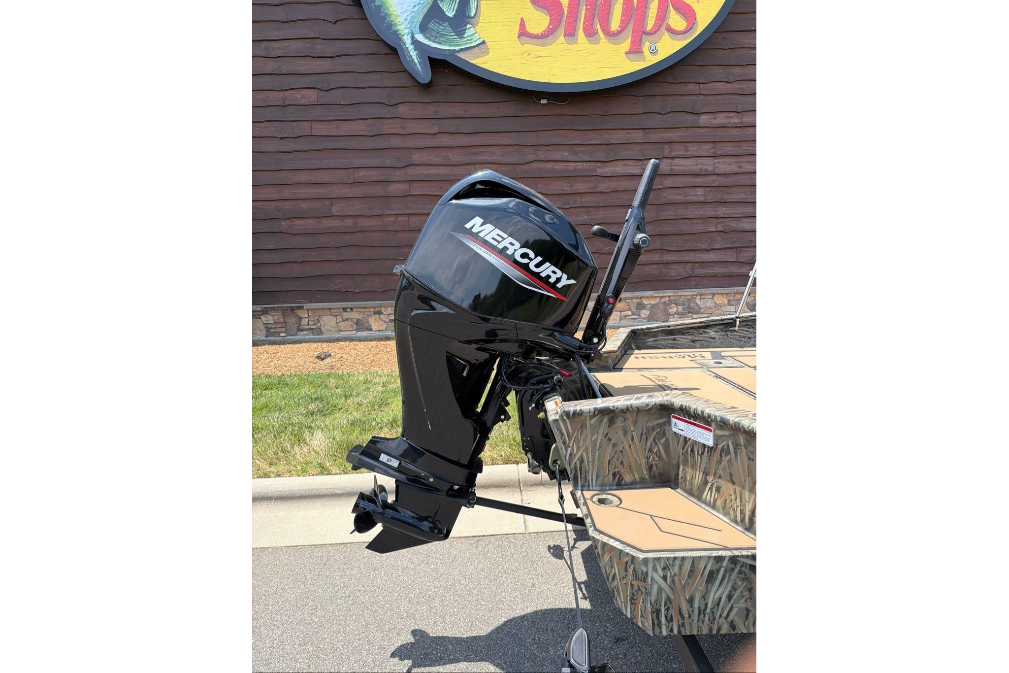 2026 Tracker Grizzly 1756 T Marsh boat with Mercury outboard motor displayed outdoors.