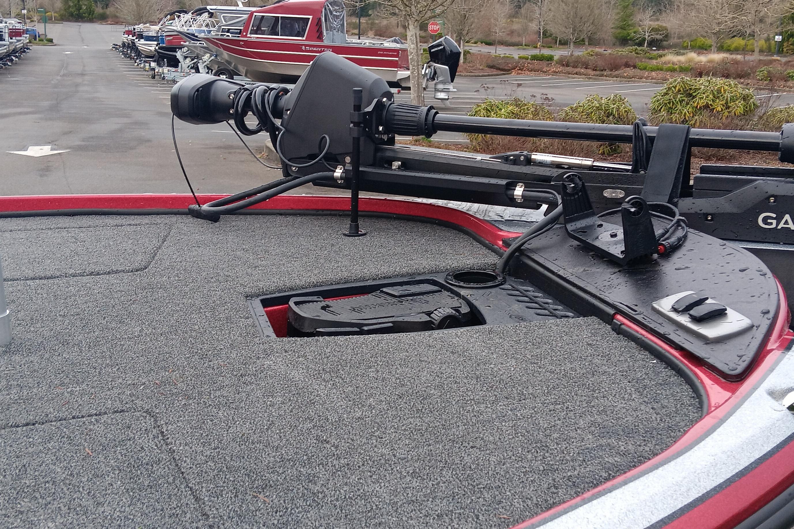 Red Nitro Z18 Pro 2026 boat with advanced trolling motor and carpeted deck in a marina.