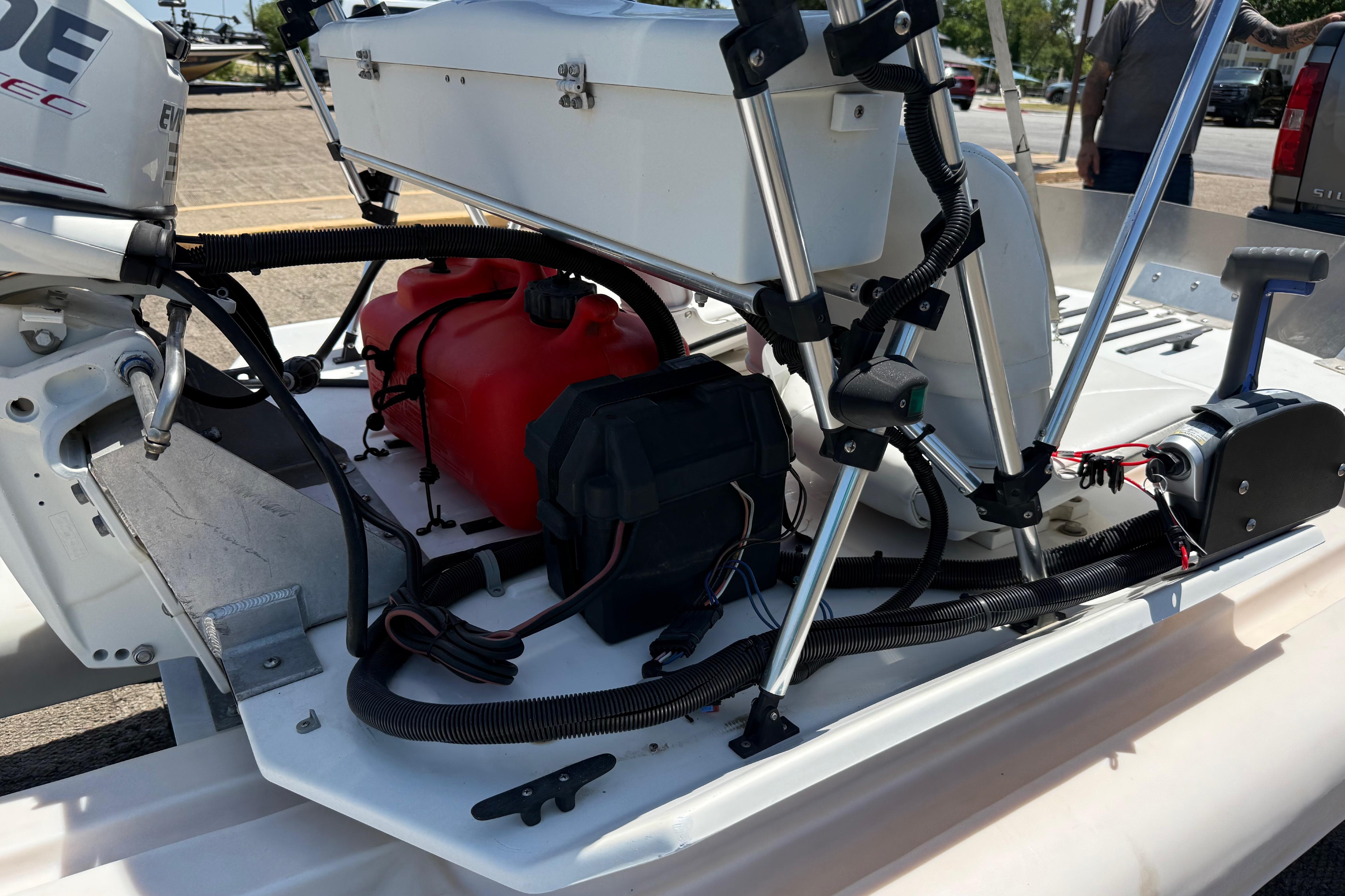 2016 CraigCat E2 Elite boat engine and components, featuring red fuel tank and wiring.