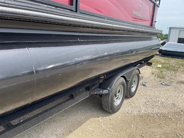 2023 Regency 250DL3 pontoon boat on a trailer, side view.