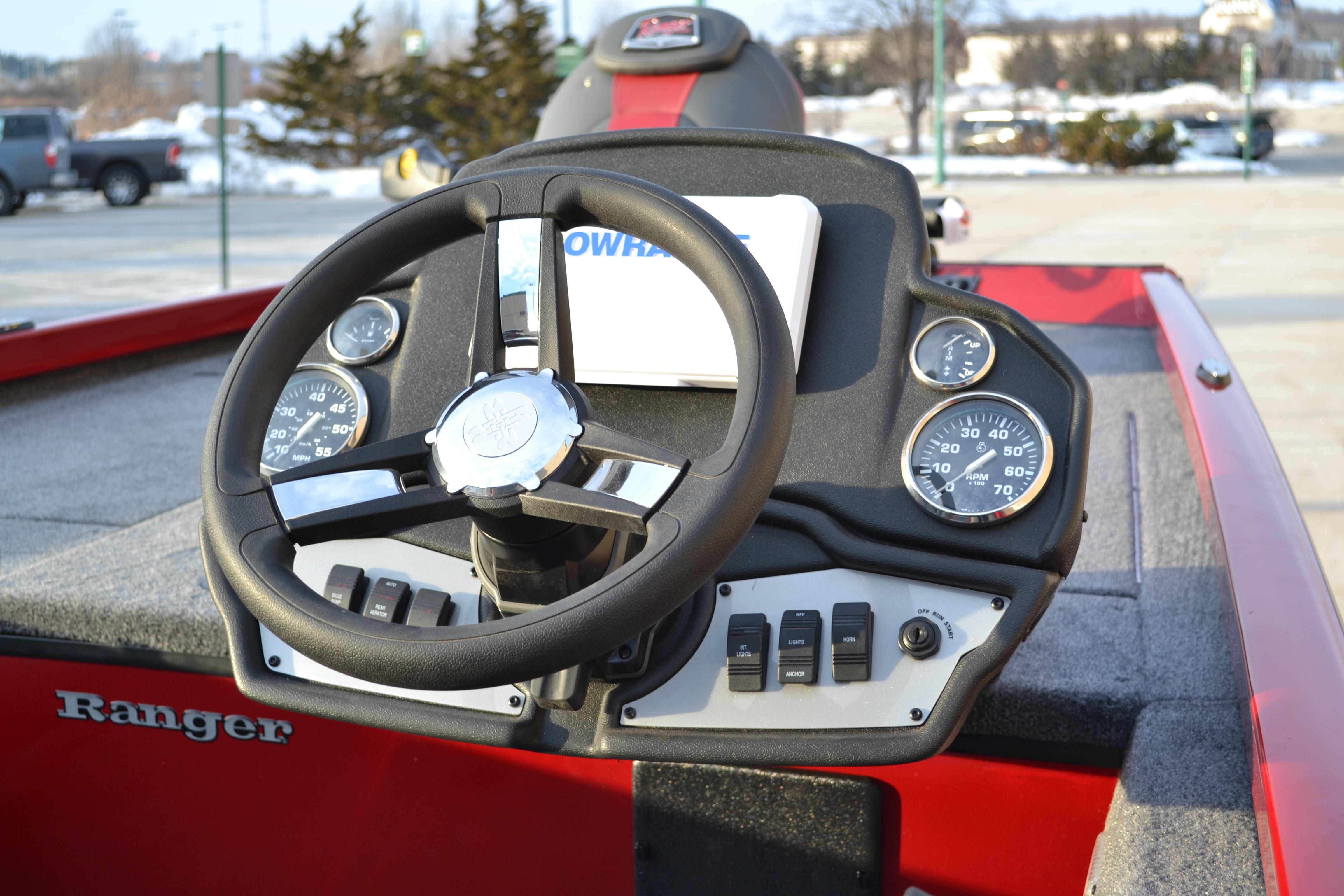 2026 Ranger RT188 boat dashboard with steering wheel and gauges in a red interior.