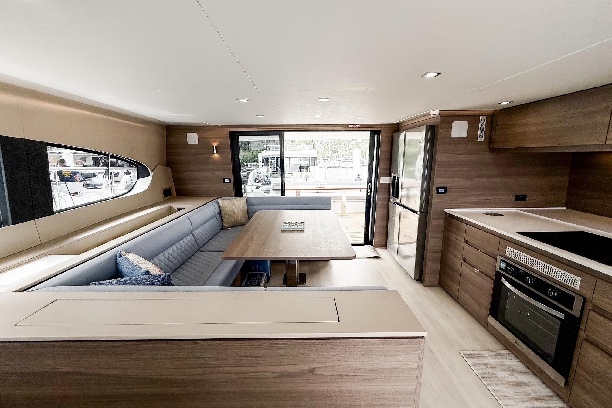 Luxurious interior of 2026 Aventura 56 yacht with modern kitchen and seating area.