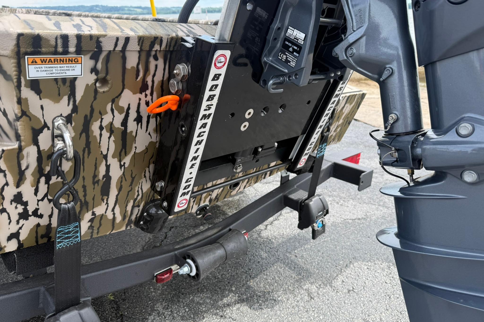 Rear view of 2026 Avid 16 Commander boat with camouflage design and motor mount.